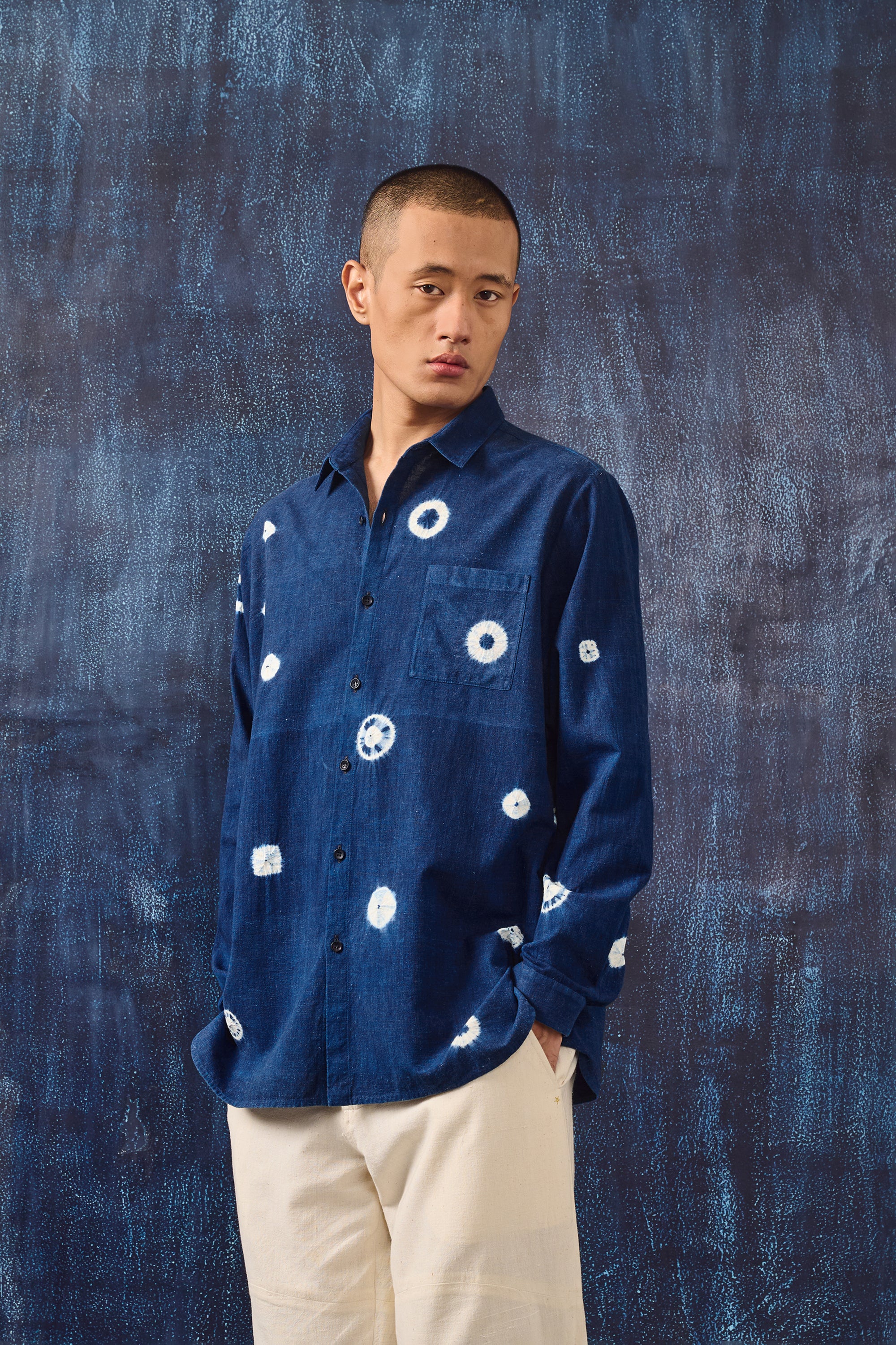 A man wearing medium indigo shirt