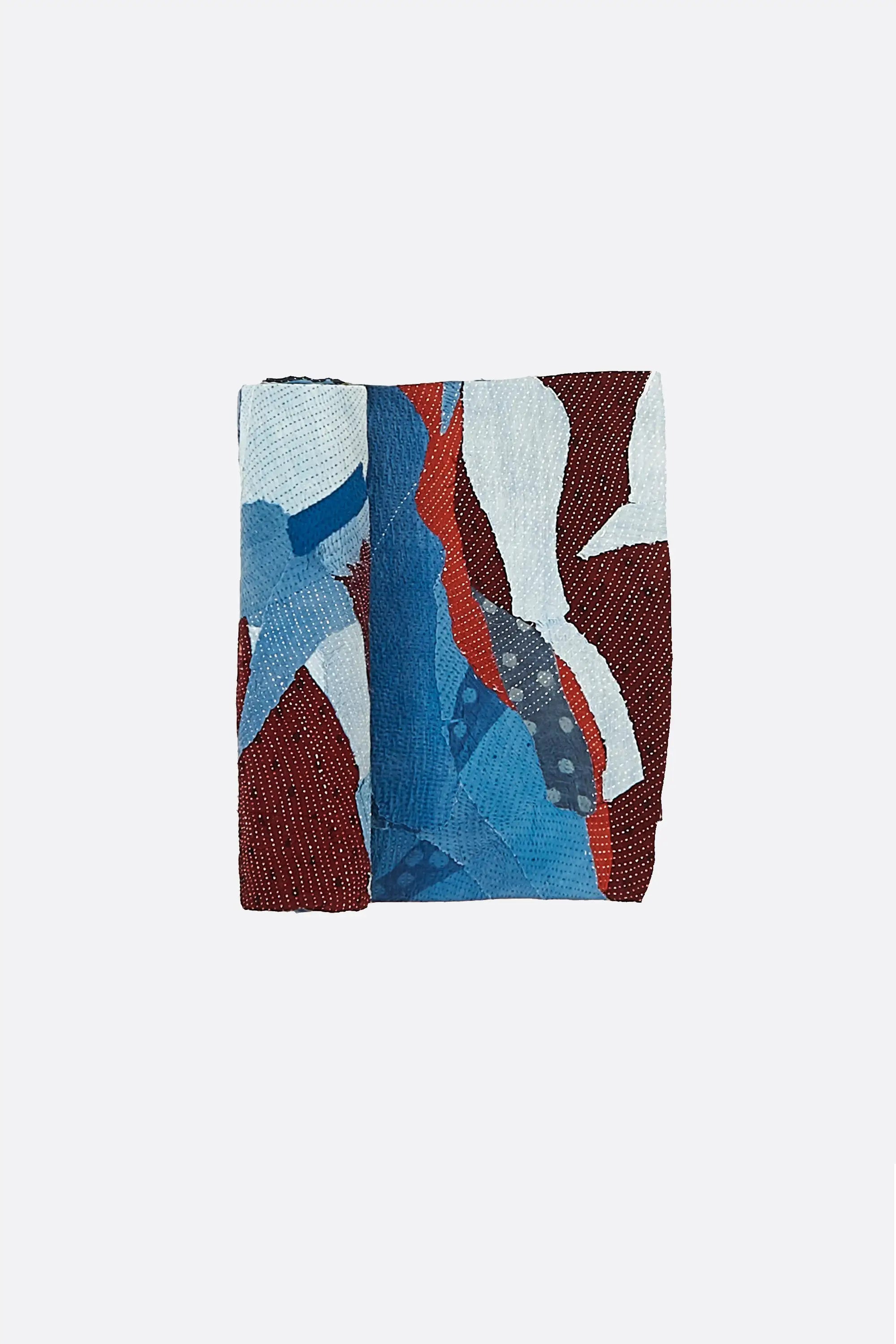 Colourful kantha quilt with abstract patterns on a grey background