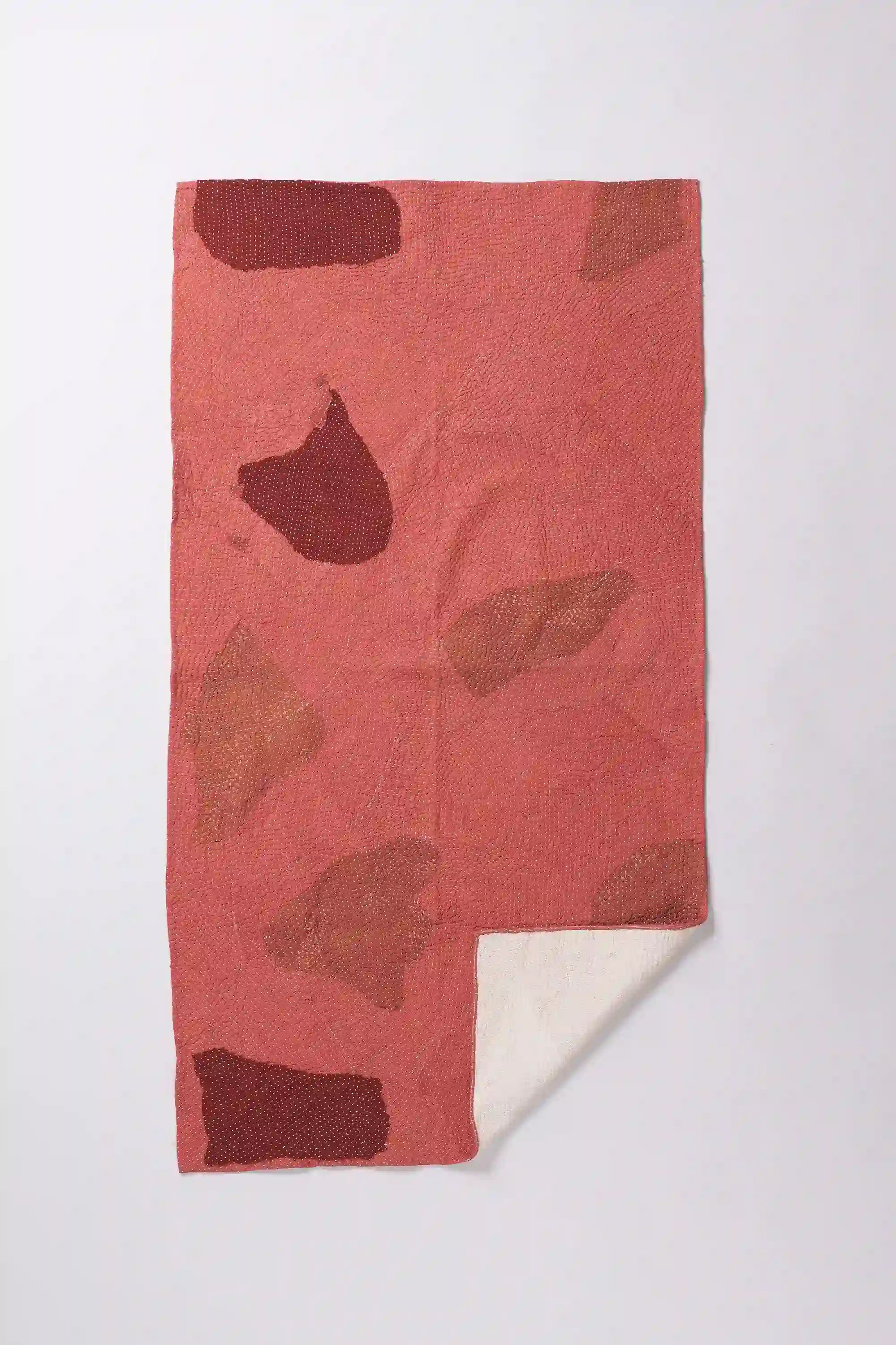 Red quilt with patchwork work