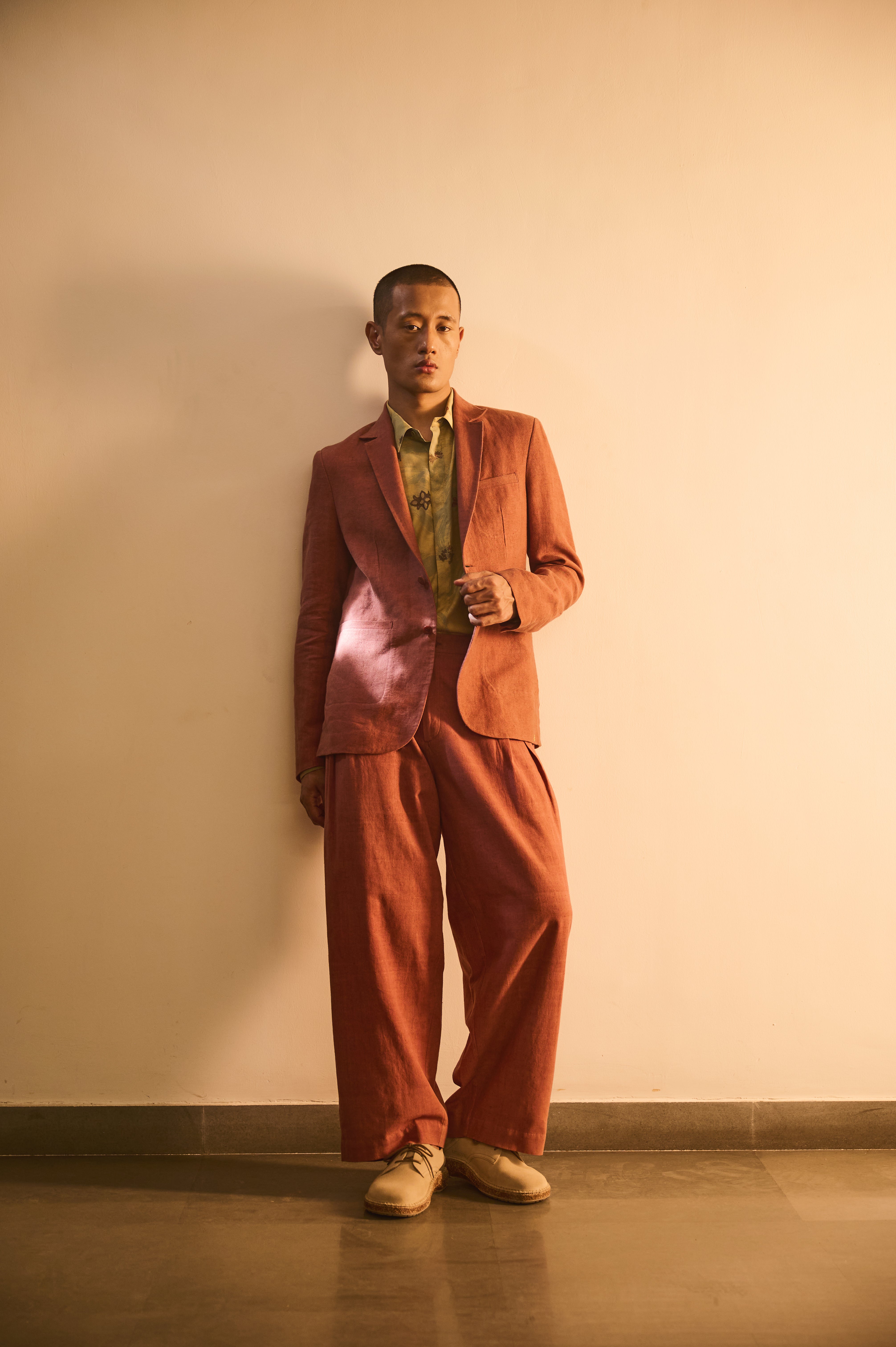 A man wearing rouge pink linen jacket