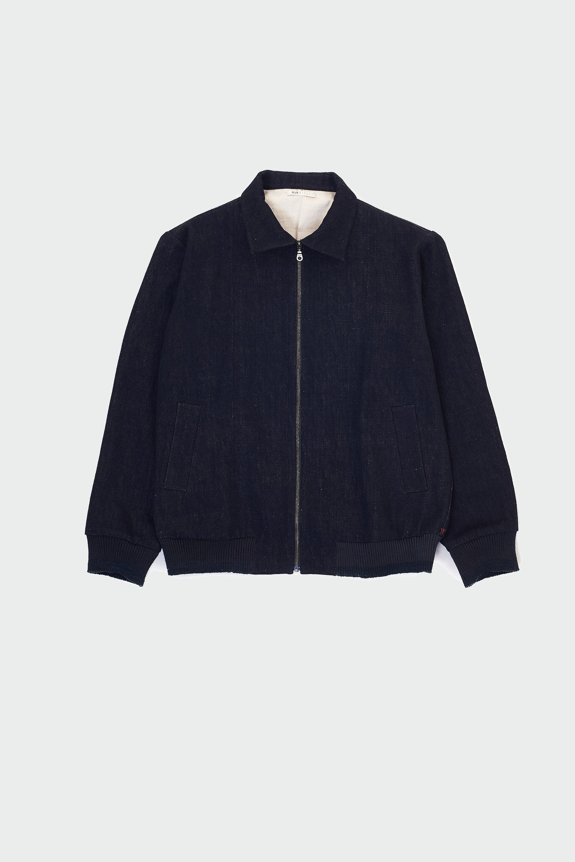 Front shot of midnight indigo jacket on a grey background