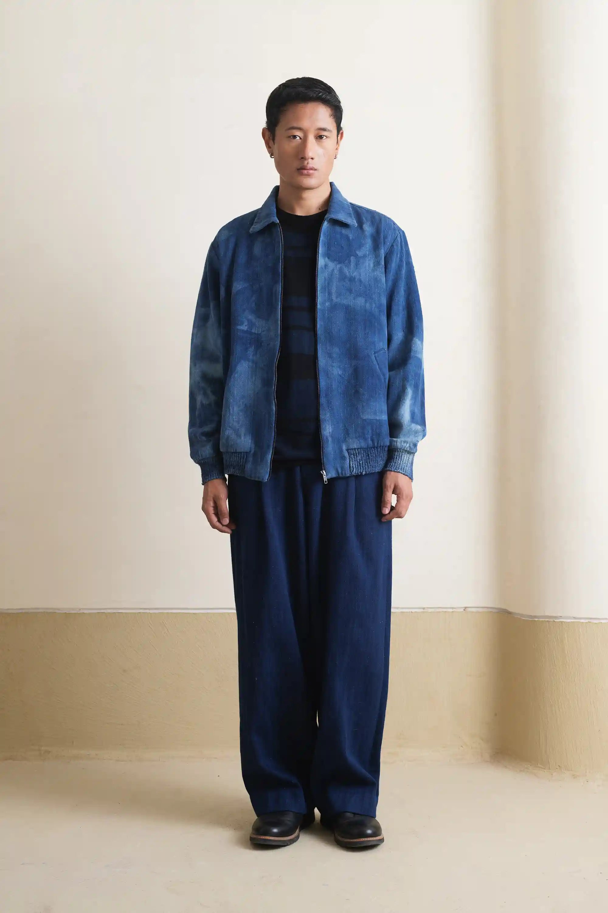 A man wearing indigo denim jacket