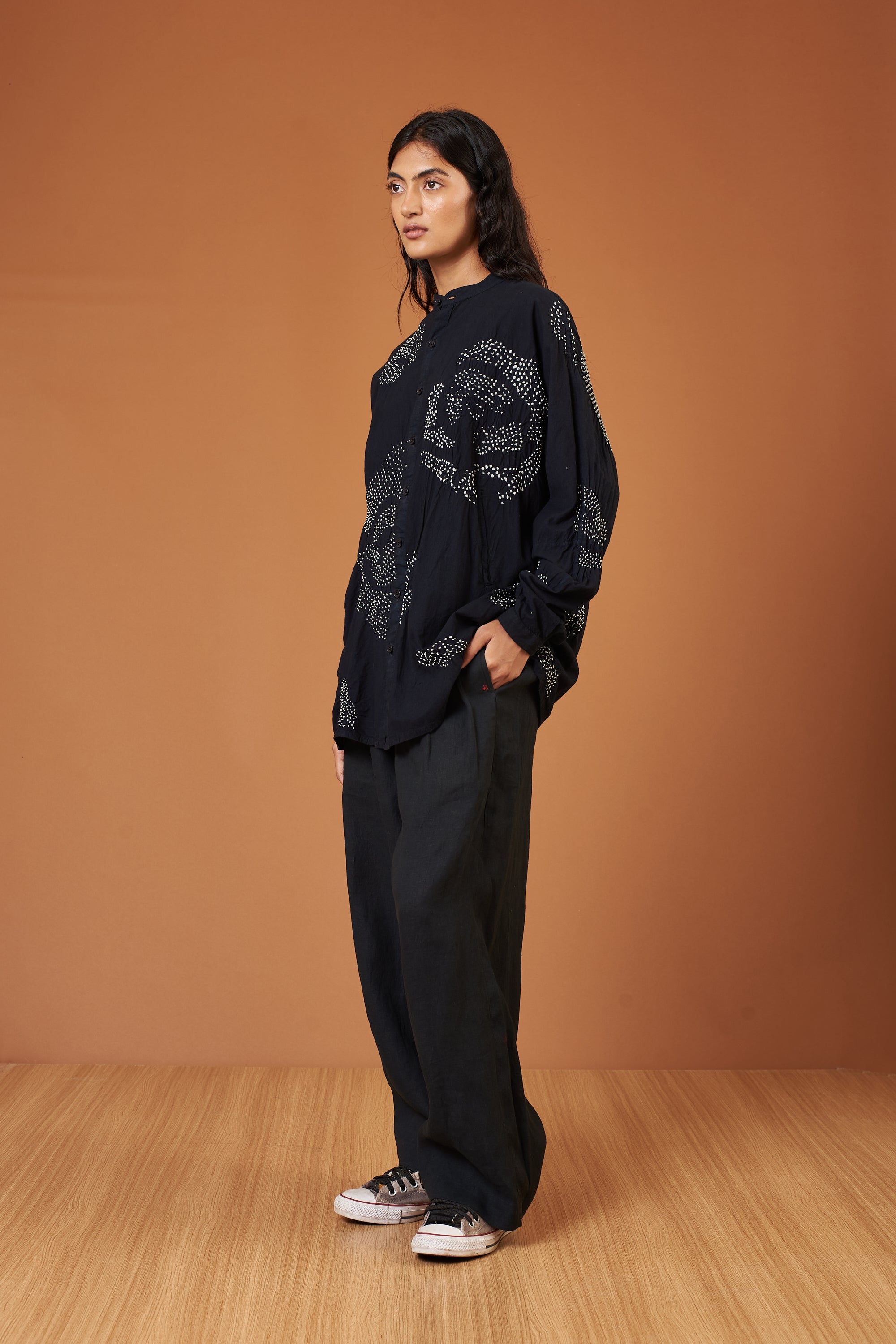 A side shot of a woman wearing black shirt
