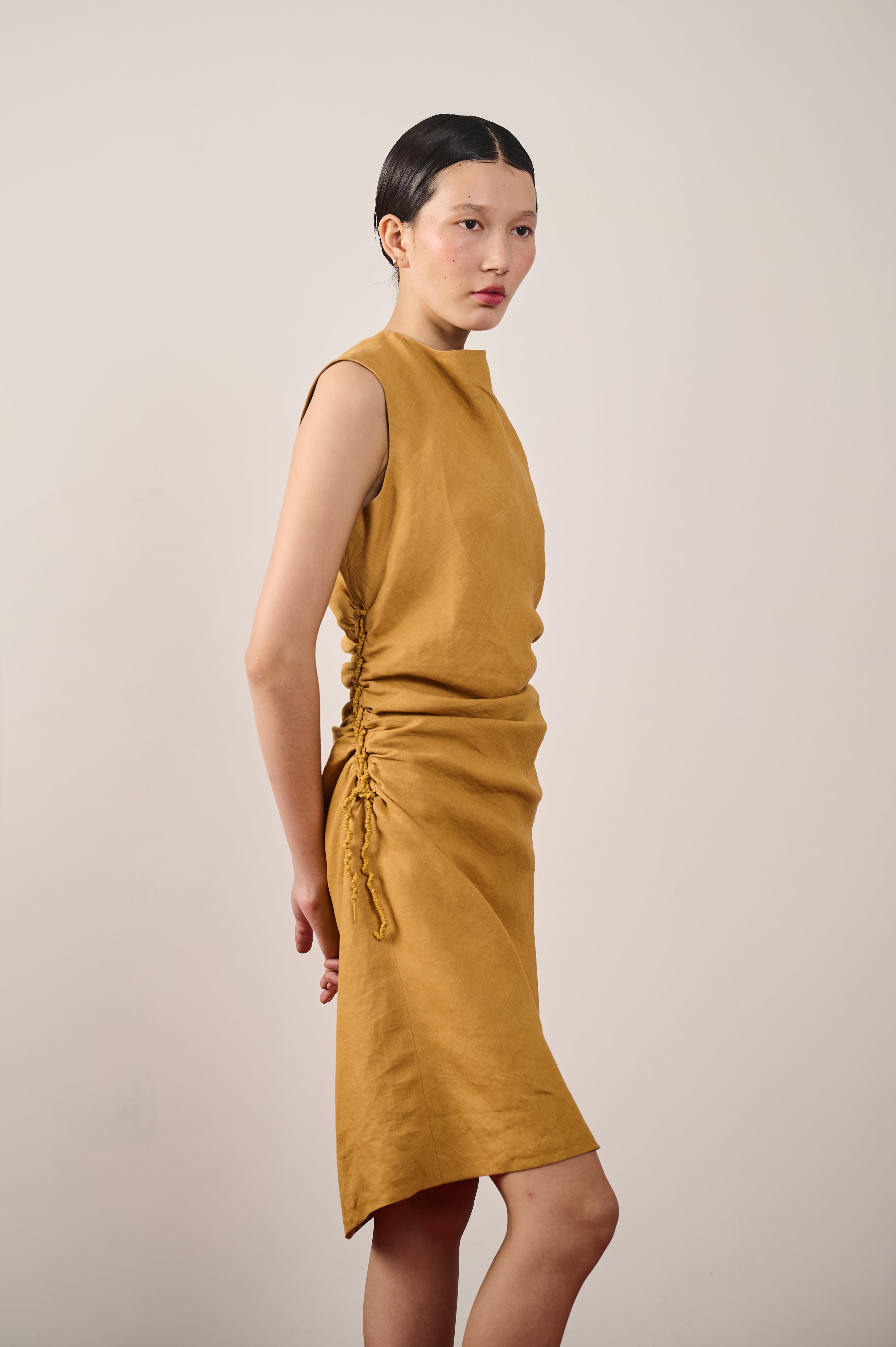 A woman wearing mustard yellow linen dress