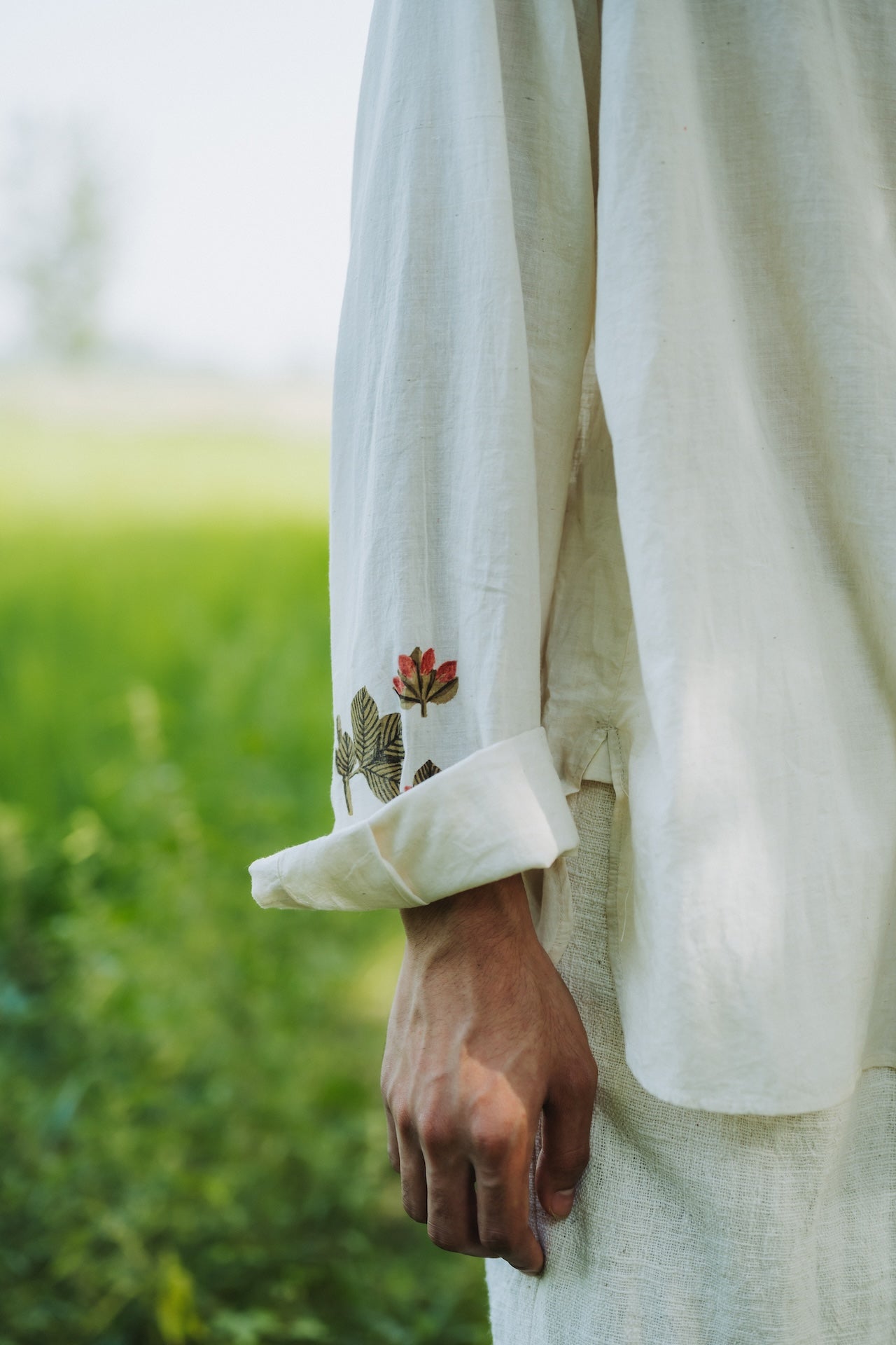 Close-up shot of a man wearing ecru cotton shirt