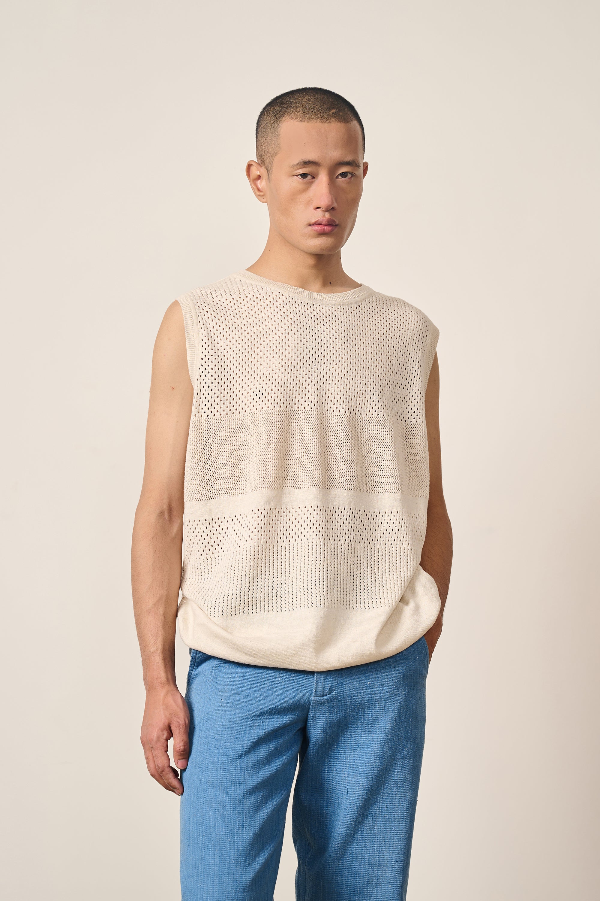 A man wearing ecru cotton knitted t-shirt