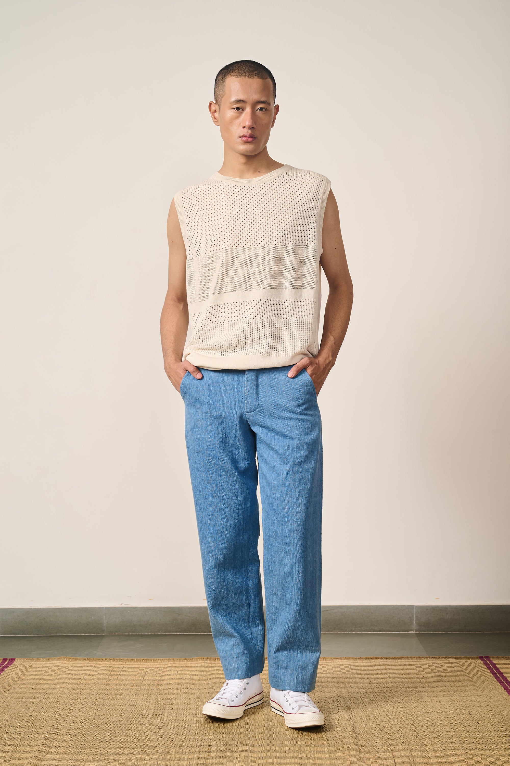 A man wearing ecru cotton knitted t-shirt