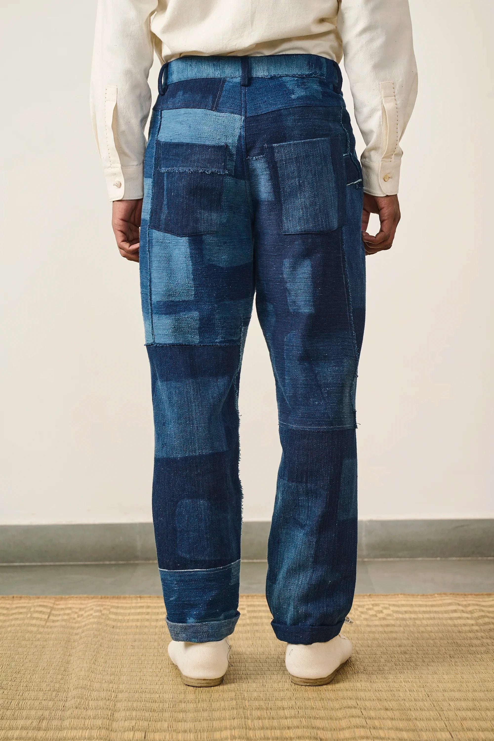 A back shot of a man wearing indigo denim pant