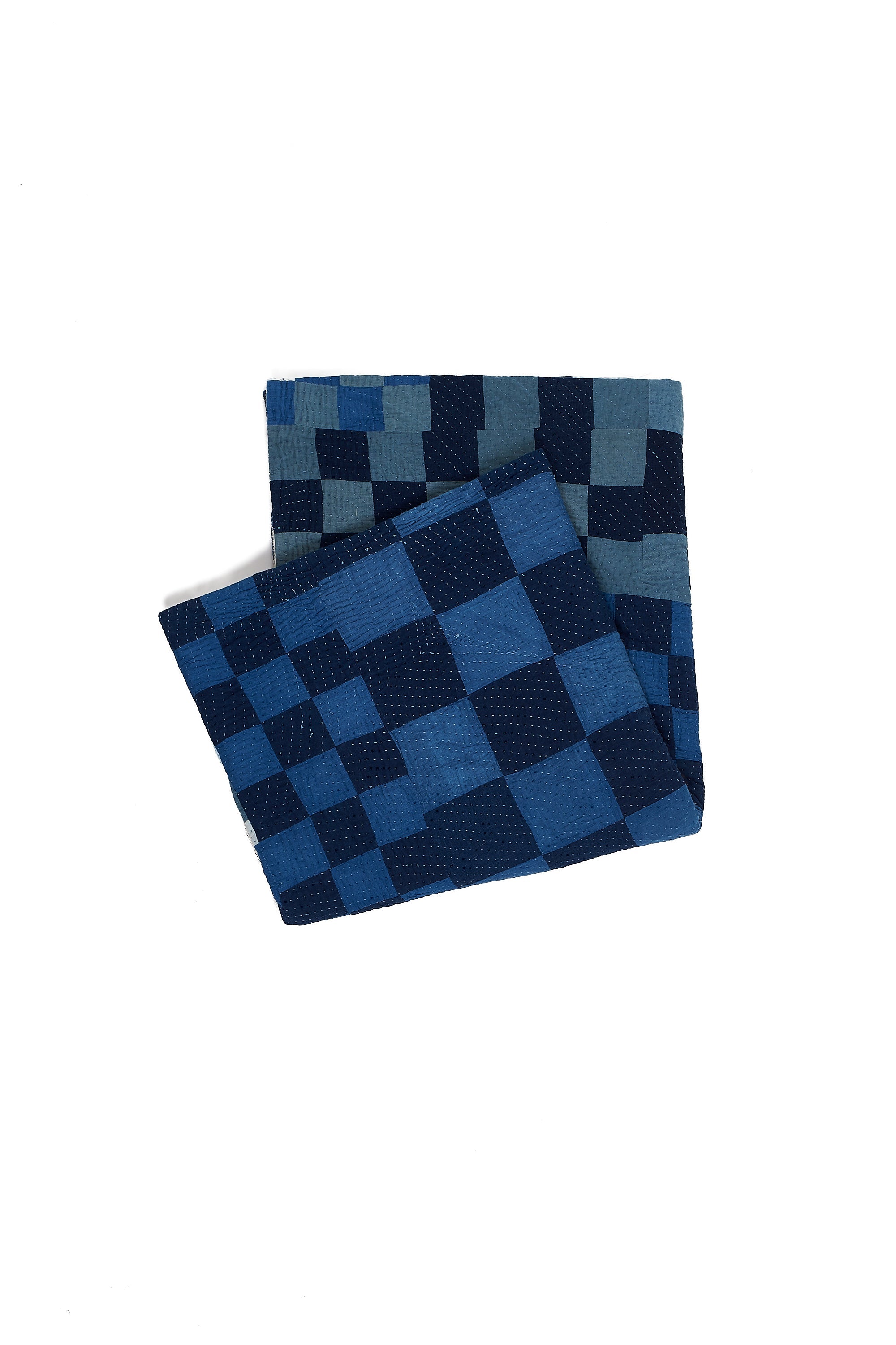 Folded indigo quilt with patchwork