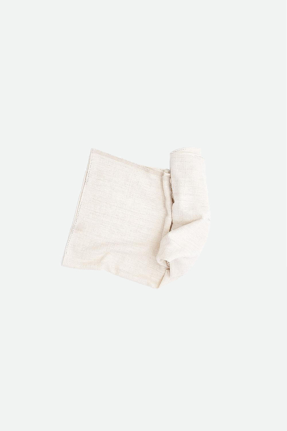 Ecru cotton towel roll on a white background