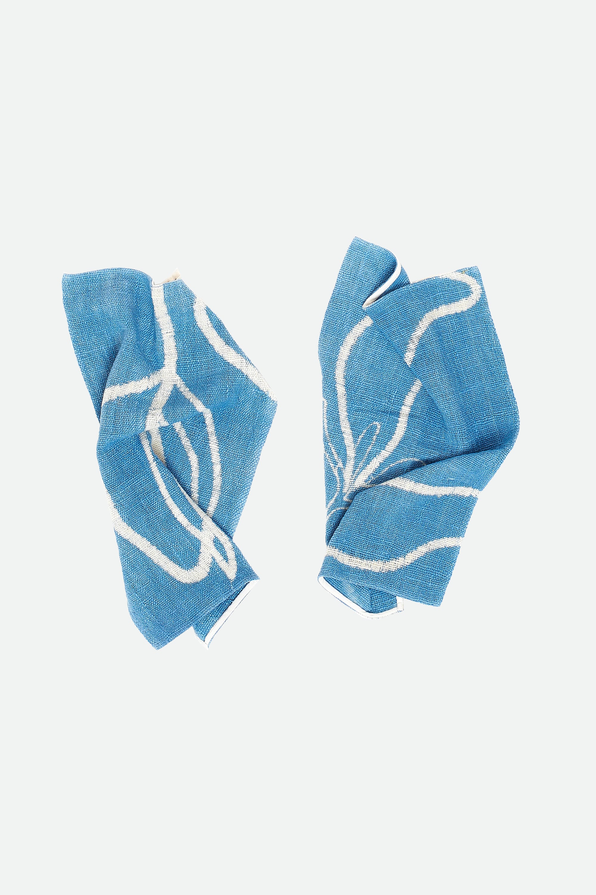 Two indigo cotton towel on a light grey background