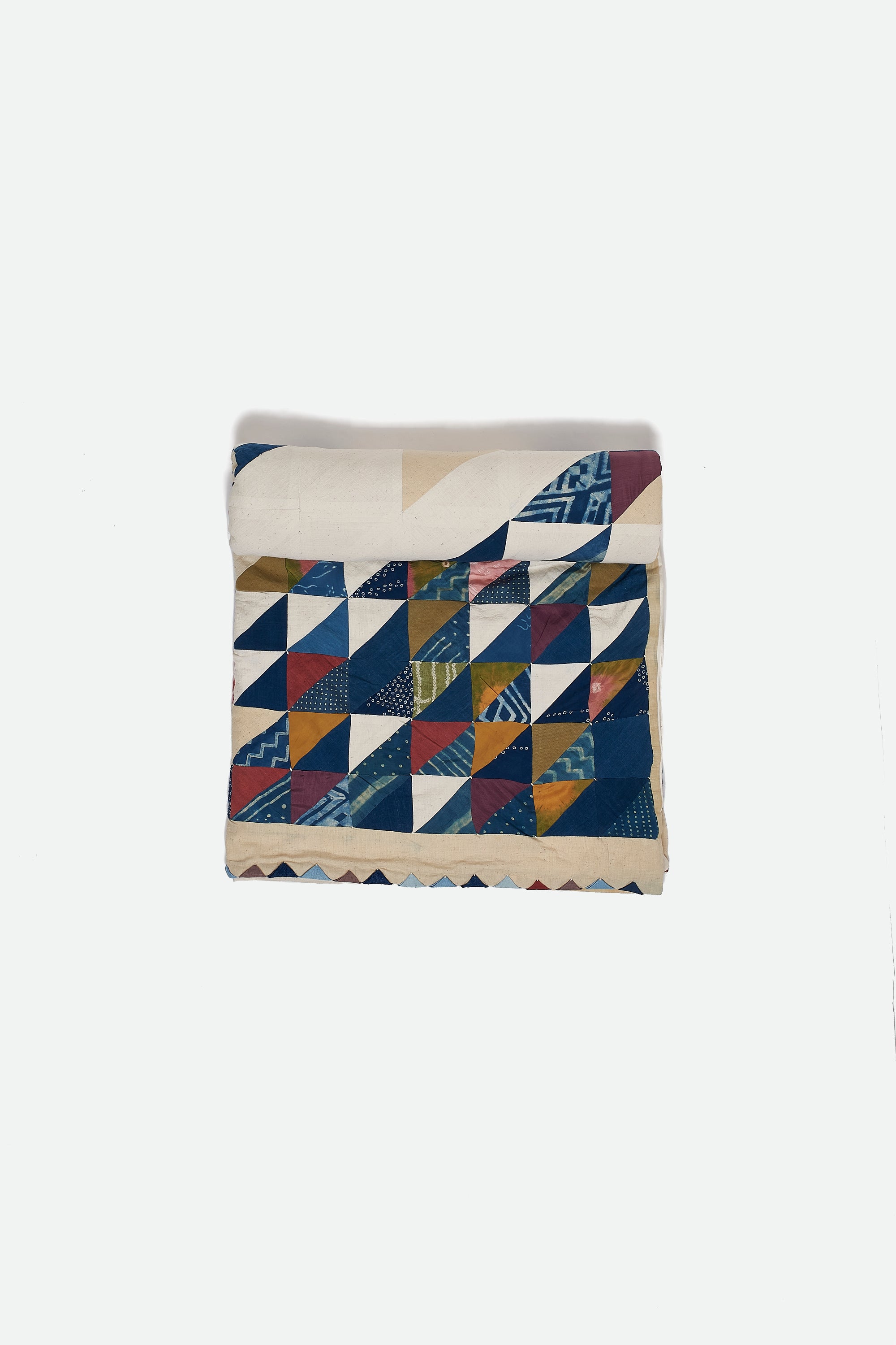 Colorful patterned quilt roll on a white background
