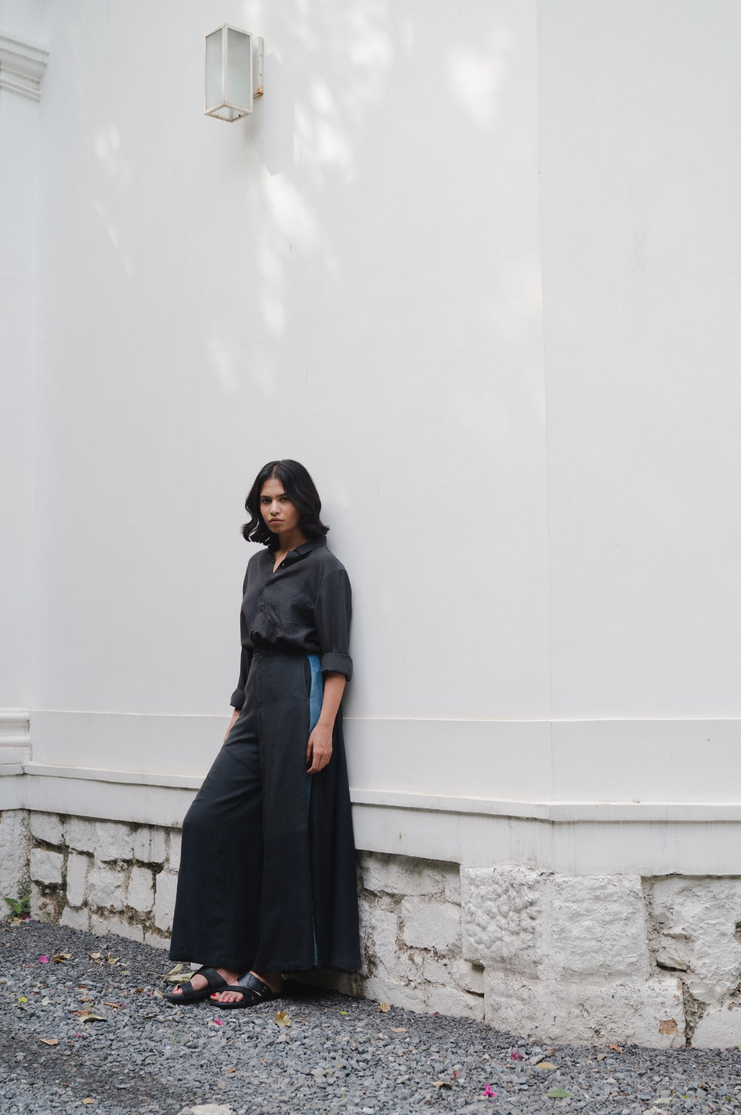 A woman wearing black silk trouser