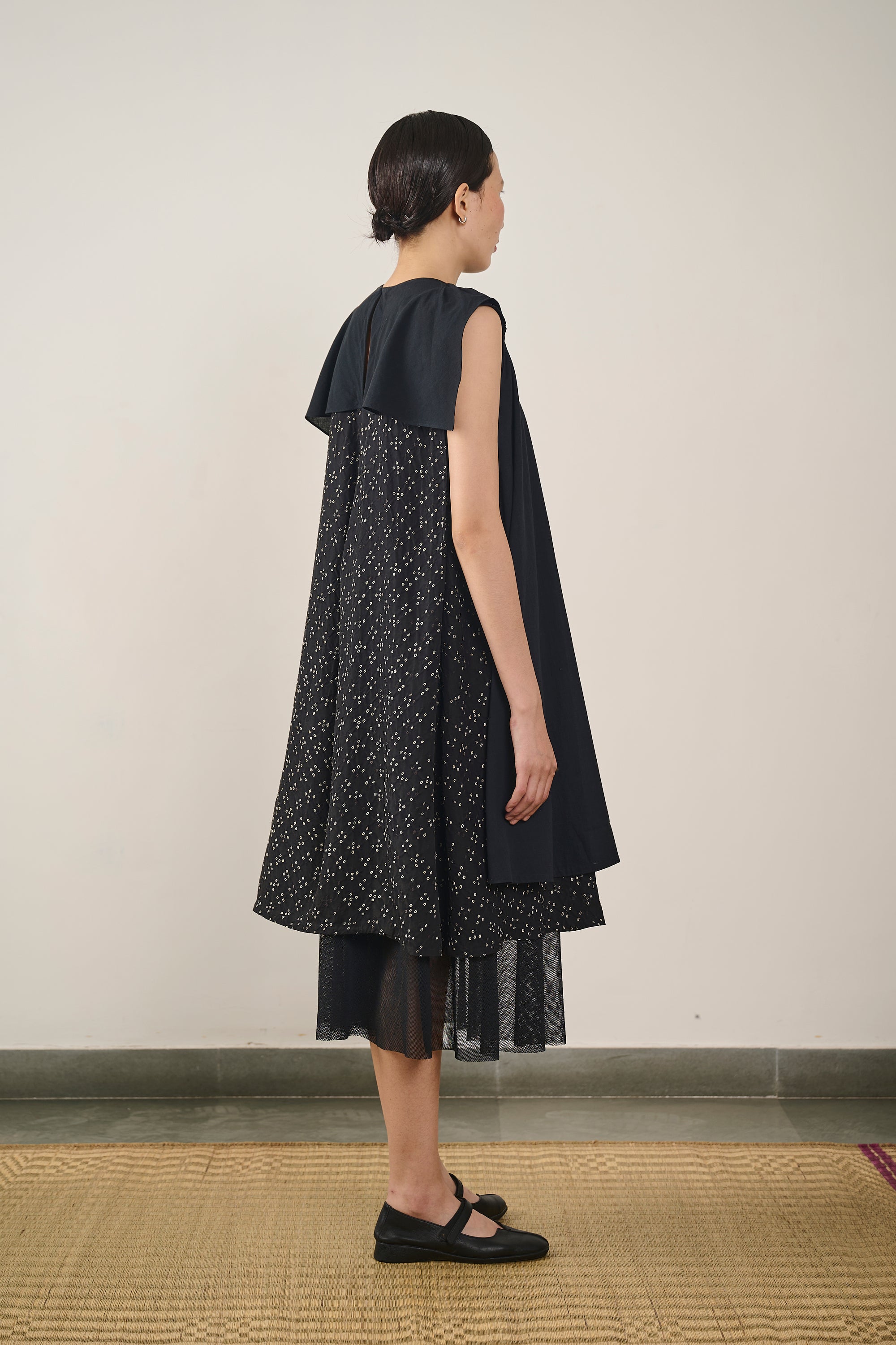 A back shot of a woman wearing black dress