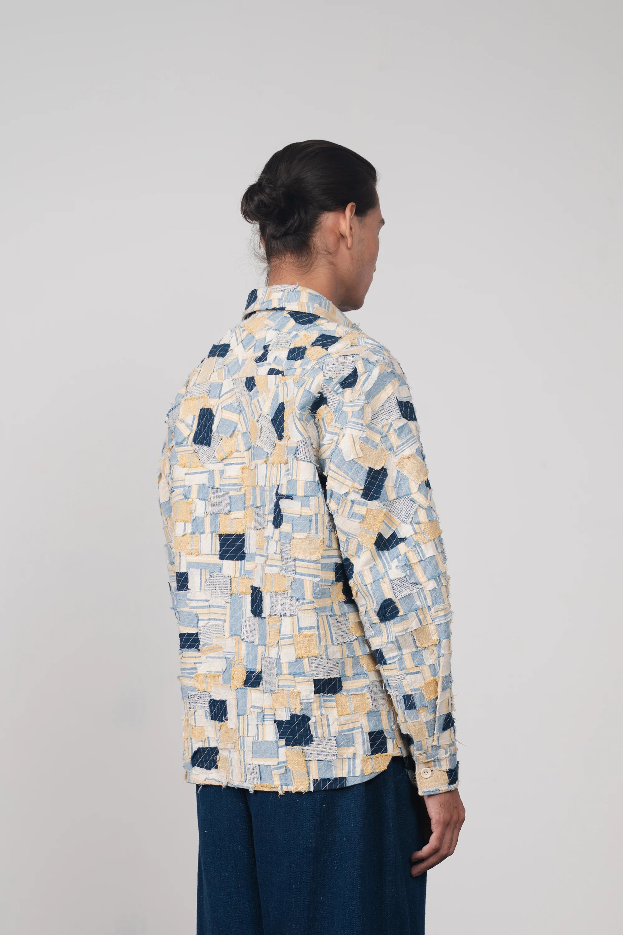 A back shot of a man wearing multi colour cotton shirt