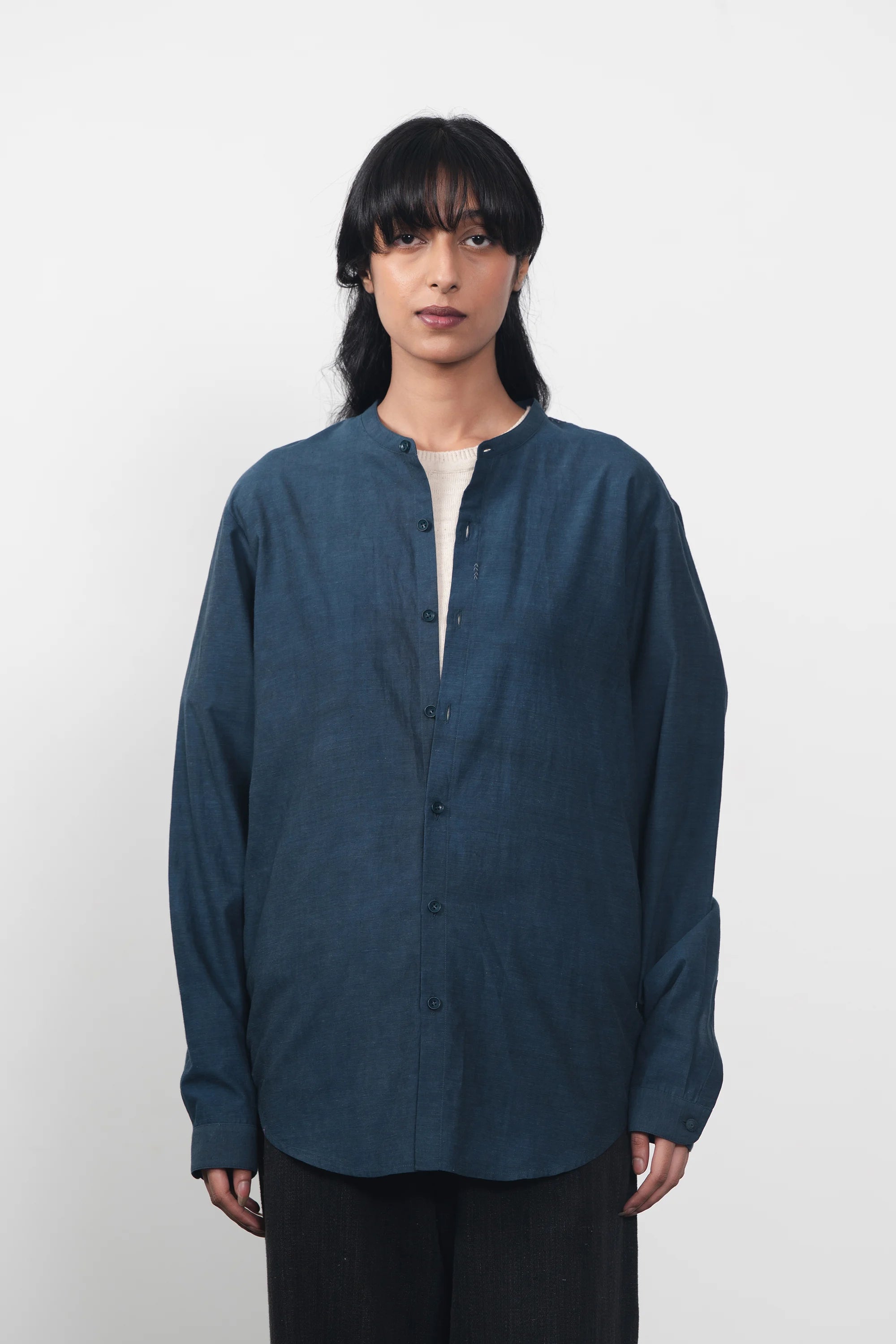 A woman wearing estate blue shirt