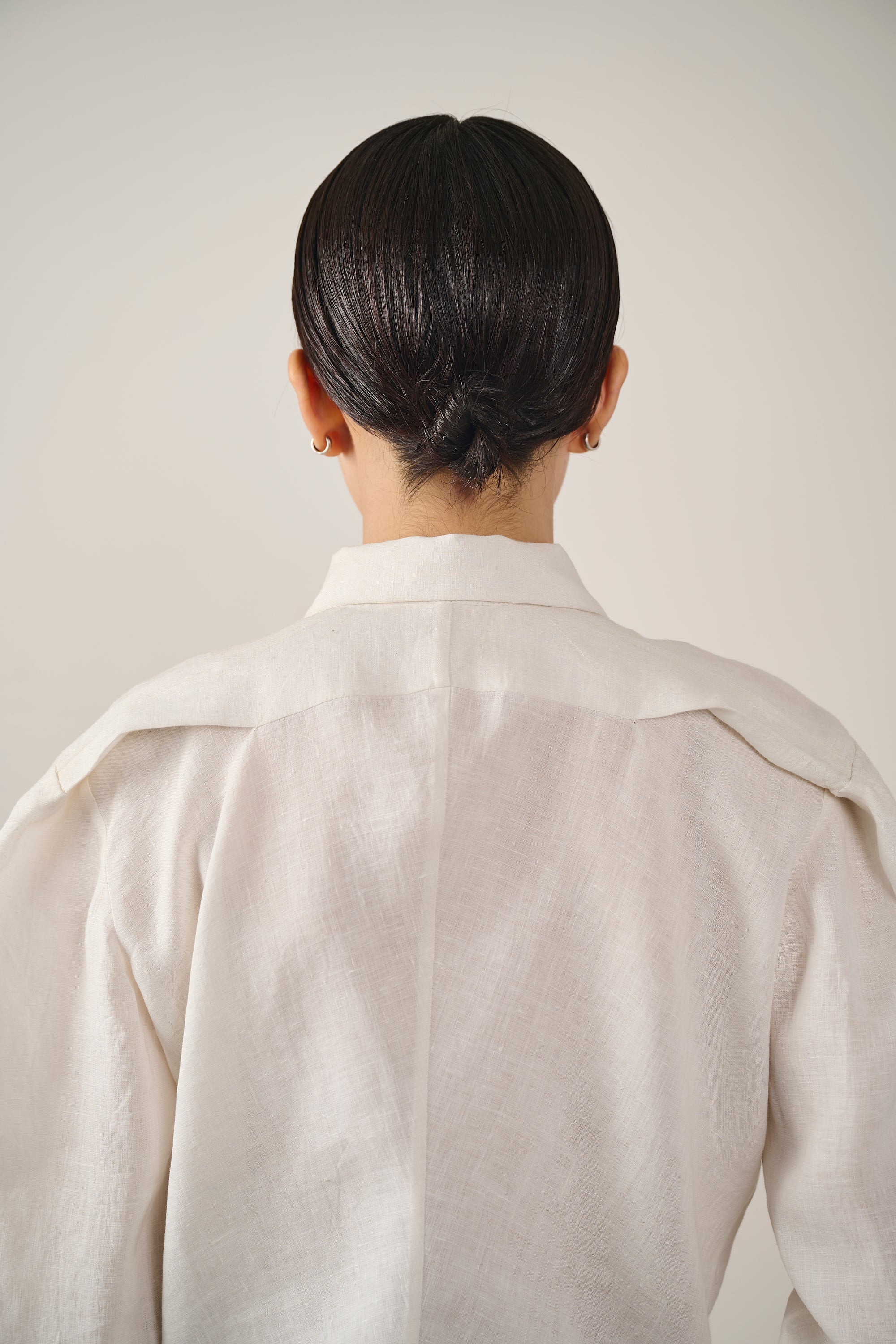 Close-up shot of a woman wearing ecru shirt
