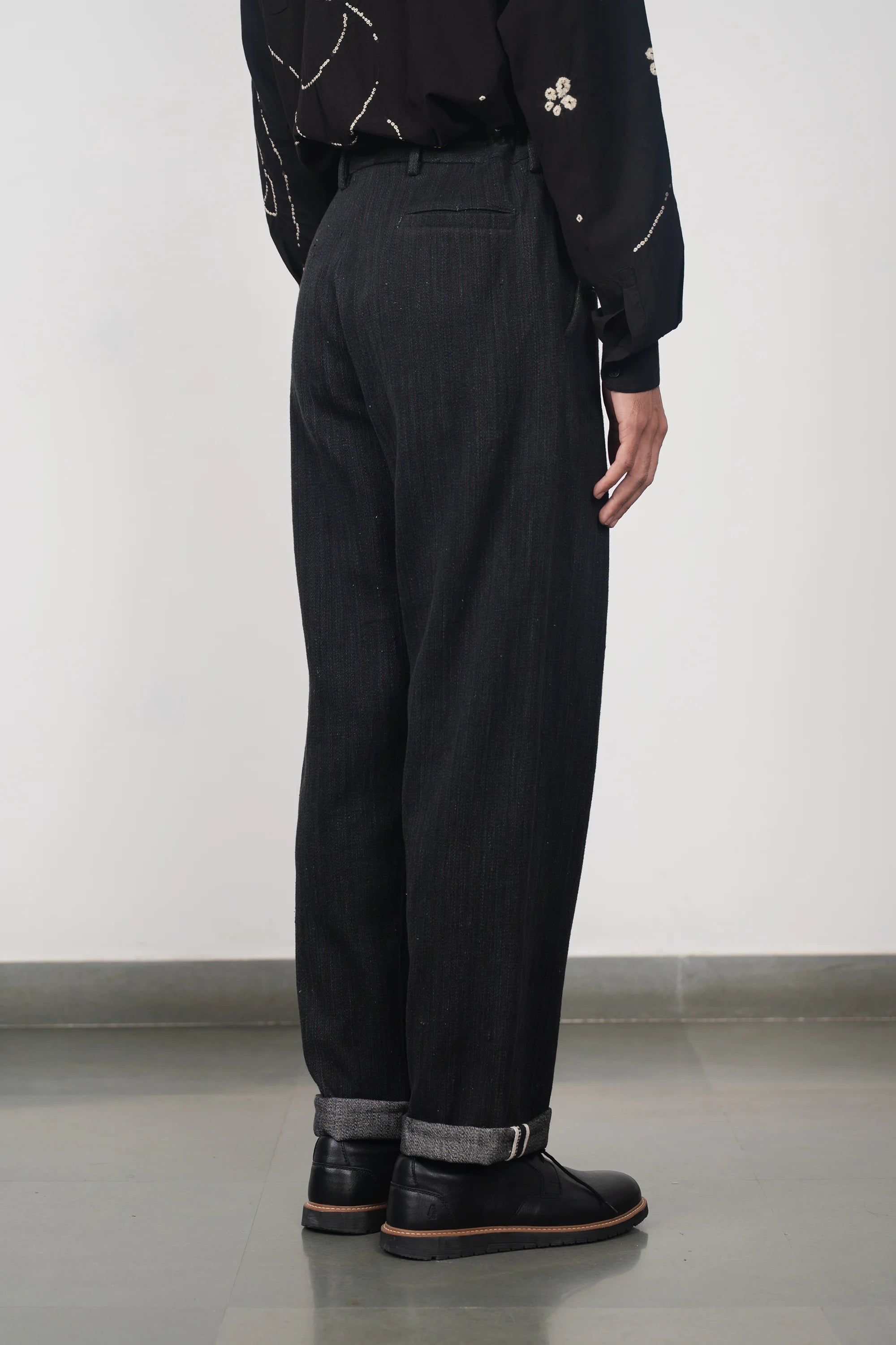 A side shot of a man wearing medium indigo denim pant