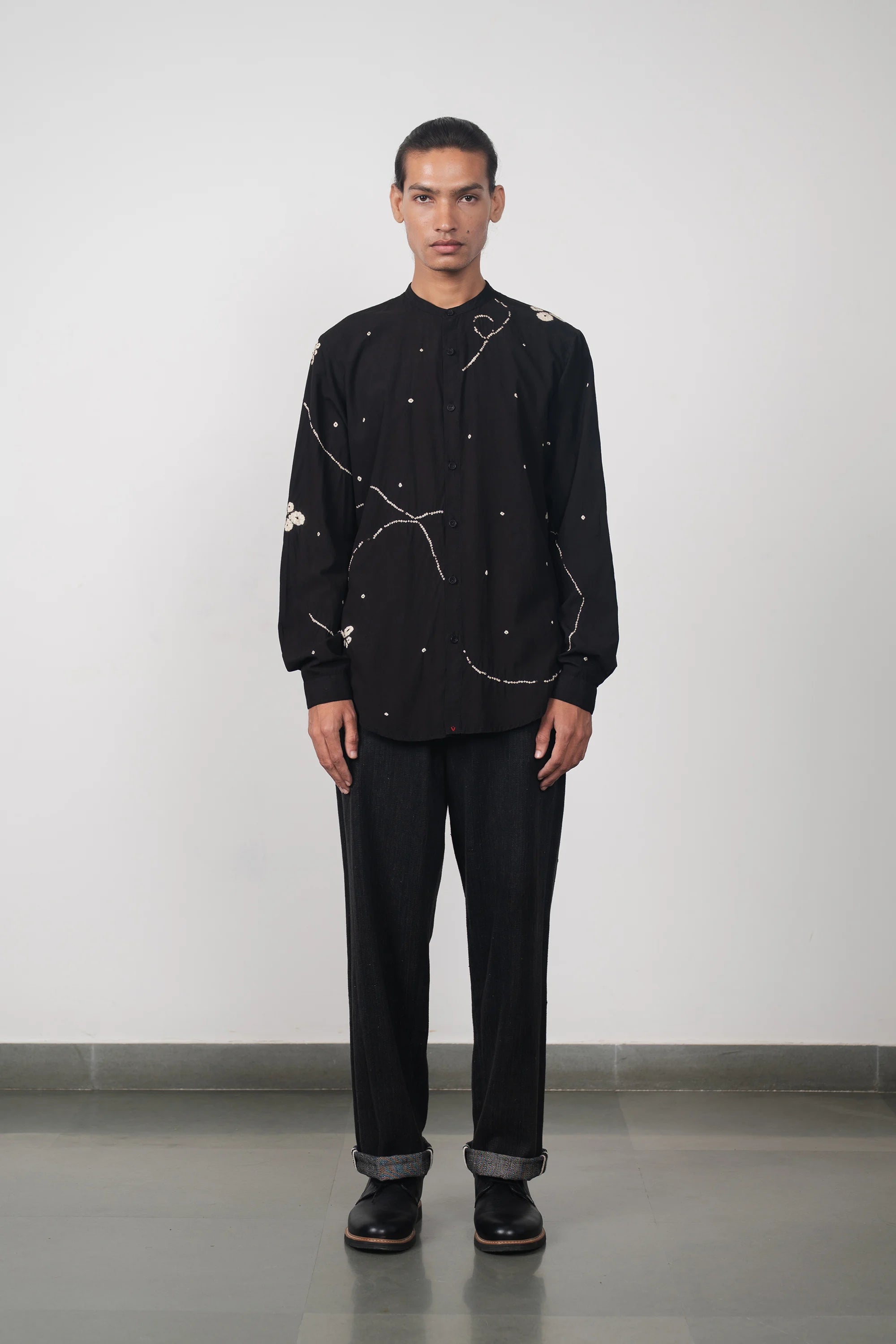 A man wearing midnight indigo denim trouser with bandhani black shirt