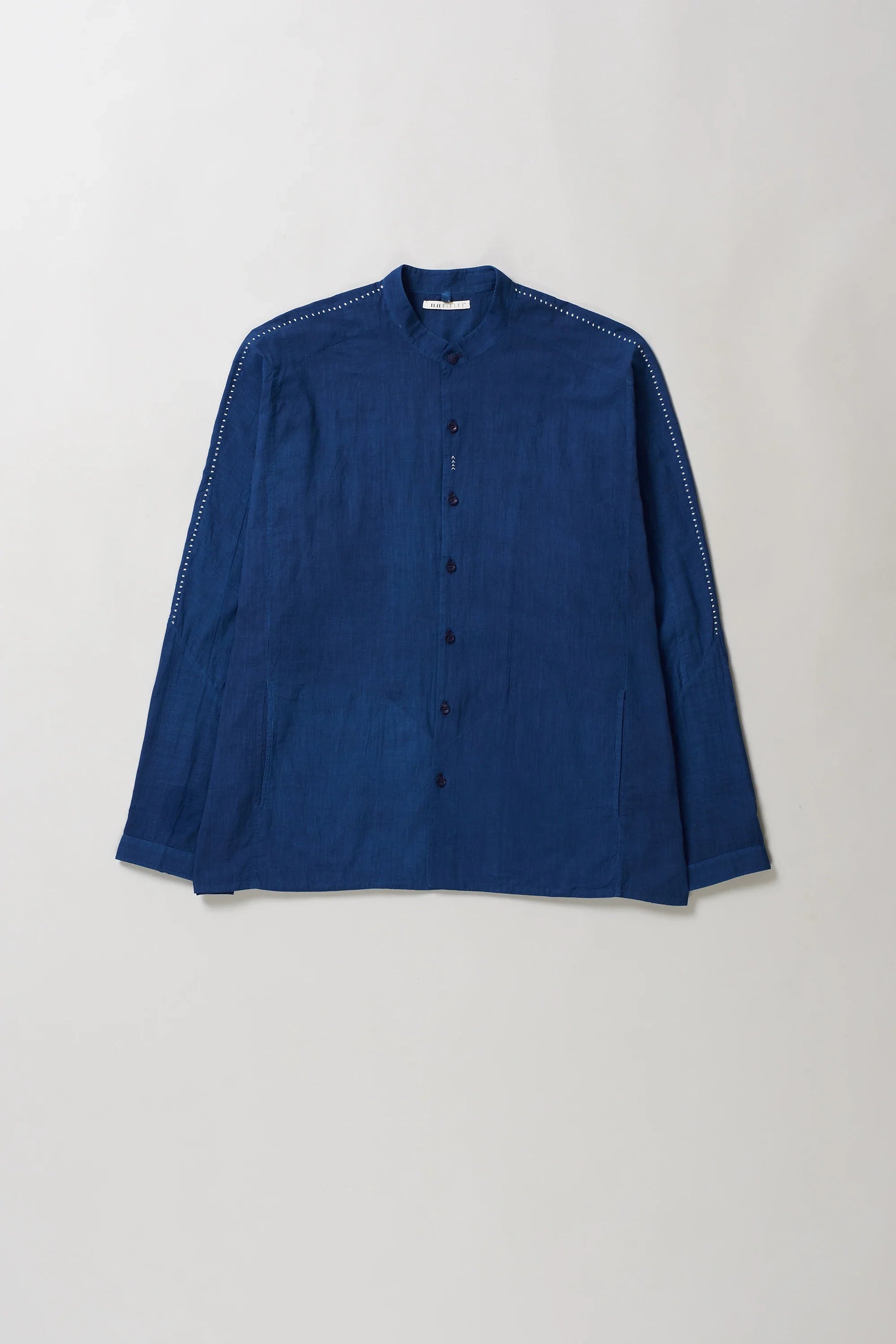 Blue cotton shirt on a light grey background