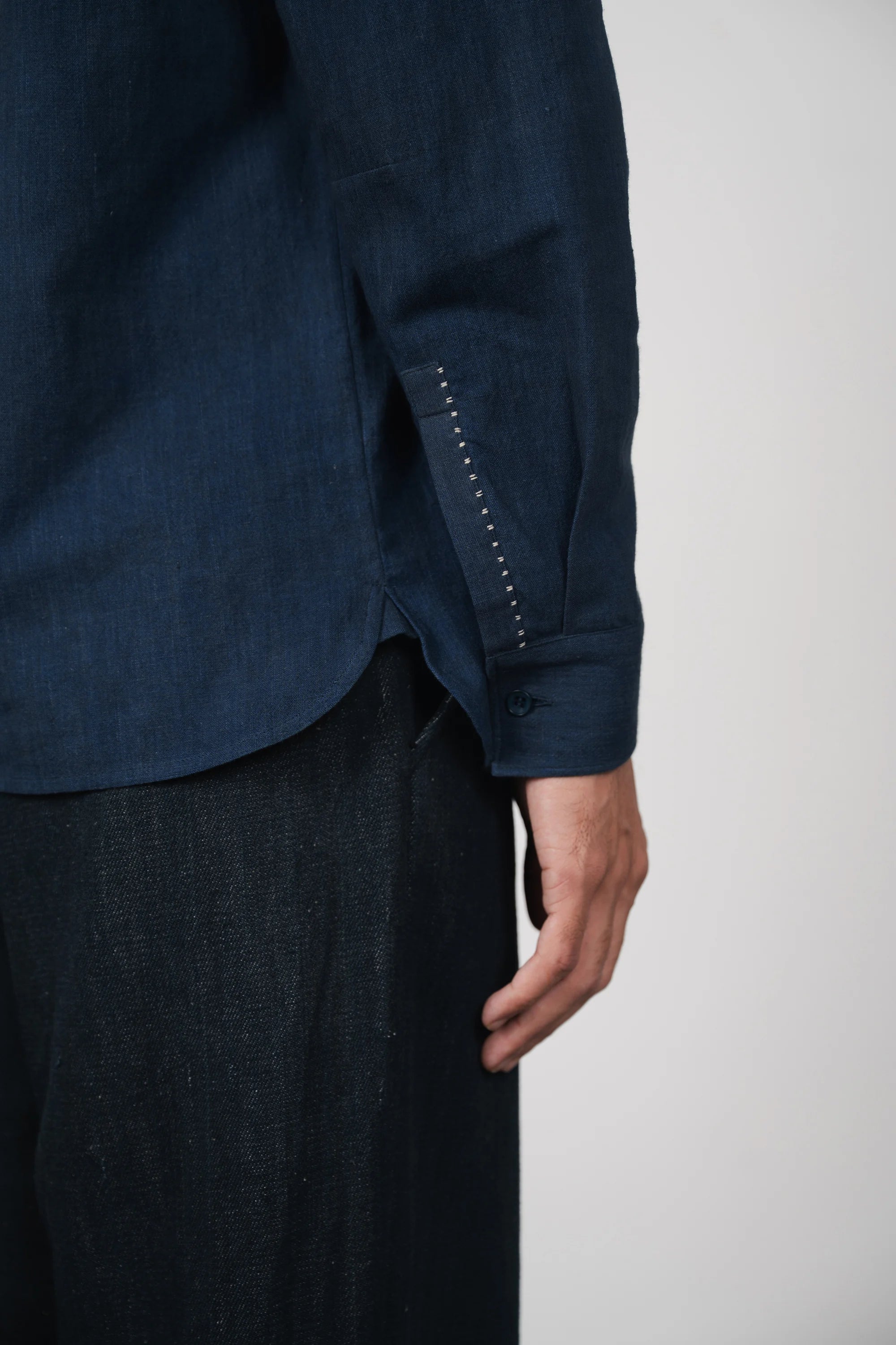 A man wearing estate blue cotton shirt
