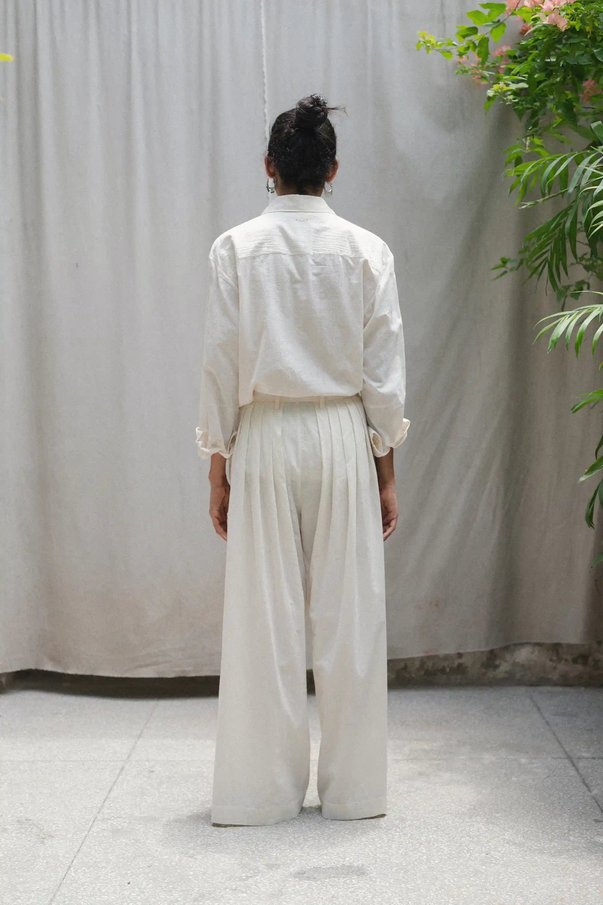 Back shot of a woman wearing ecru cotton shirt