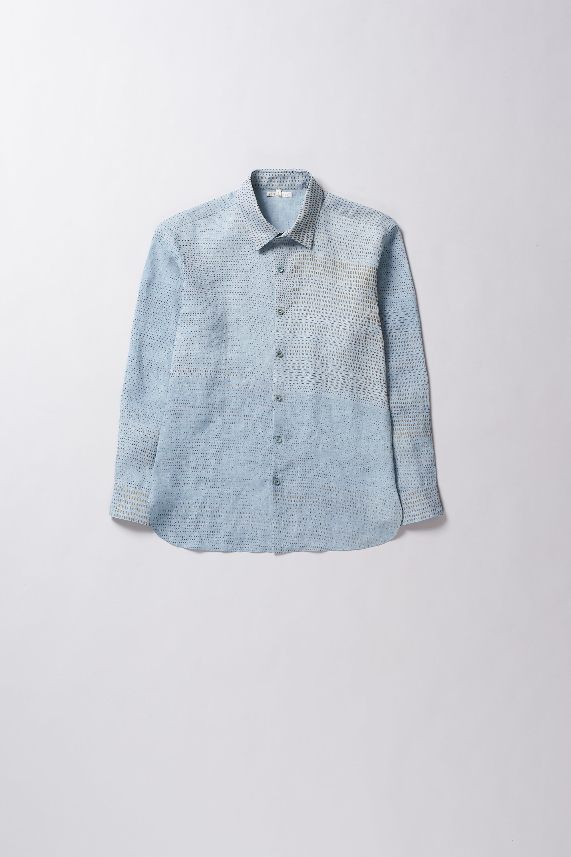 Light blue textured shirt with collar and buttons on a light gray background