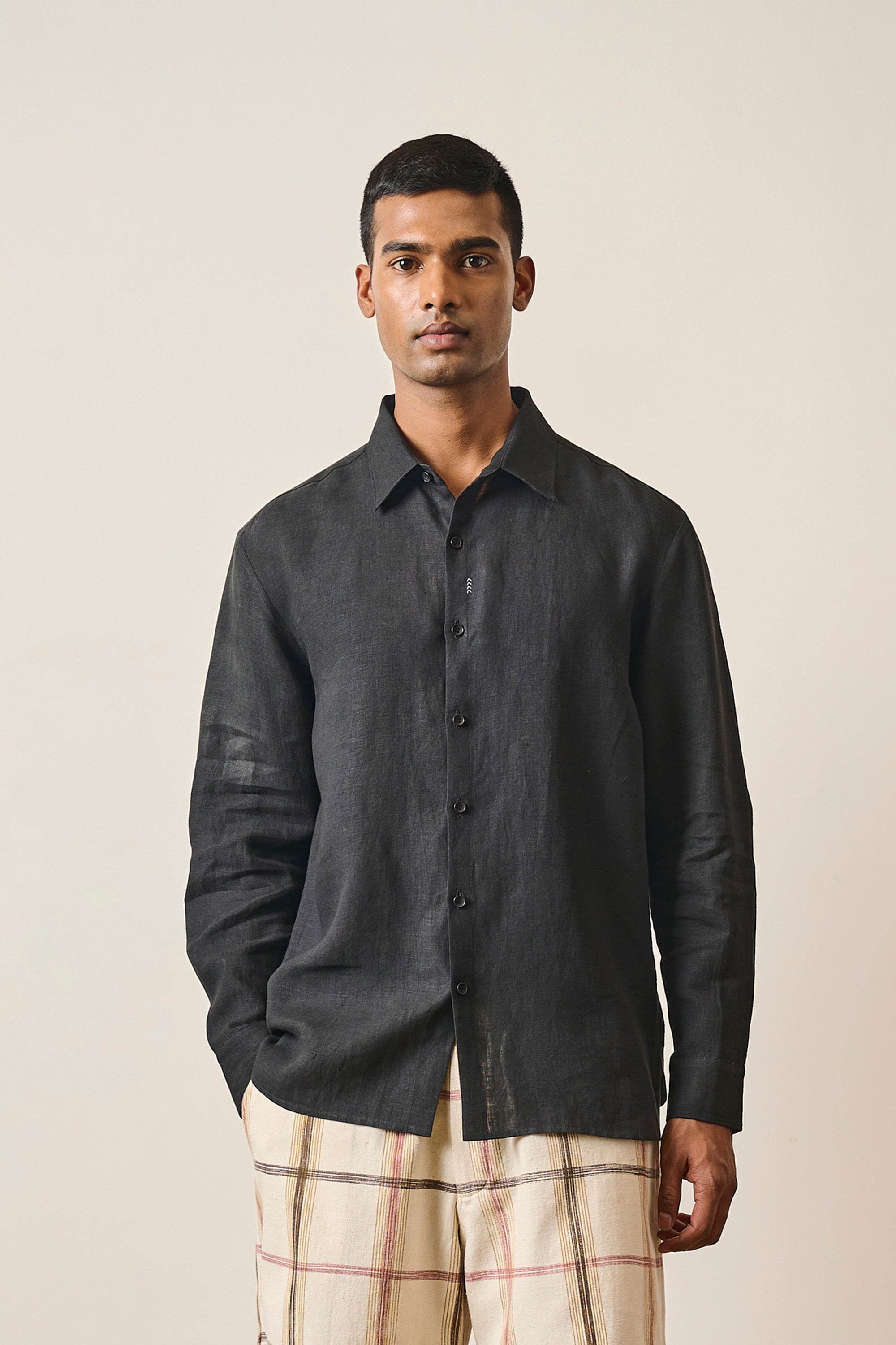 A man wearing black linen shirt