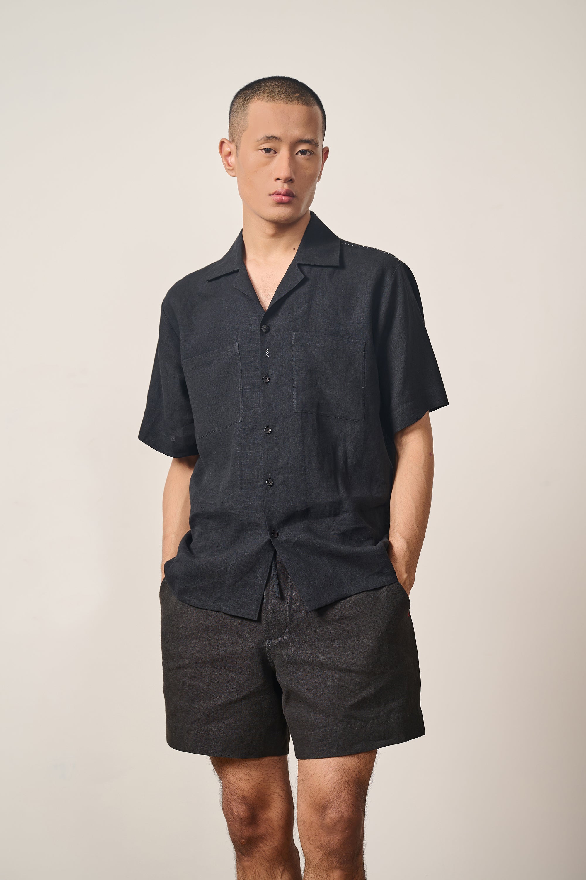 A man wearing black linen shirt