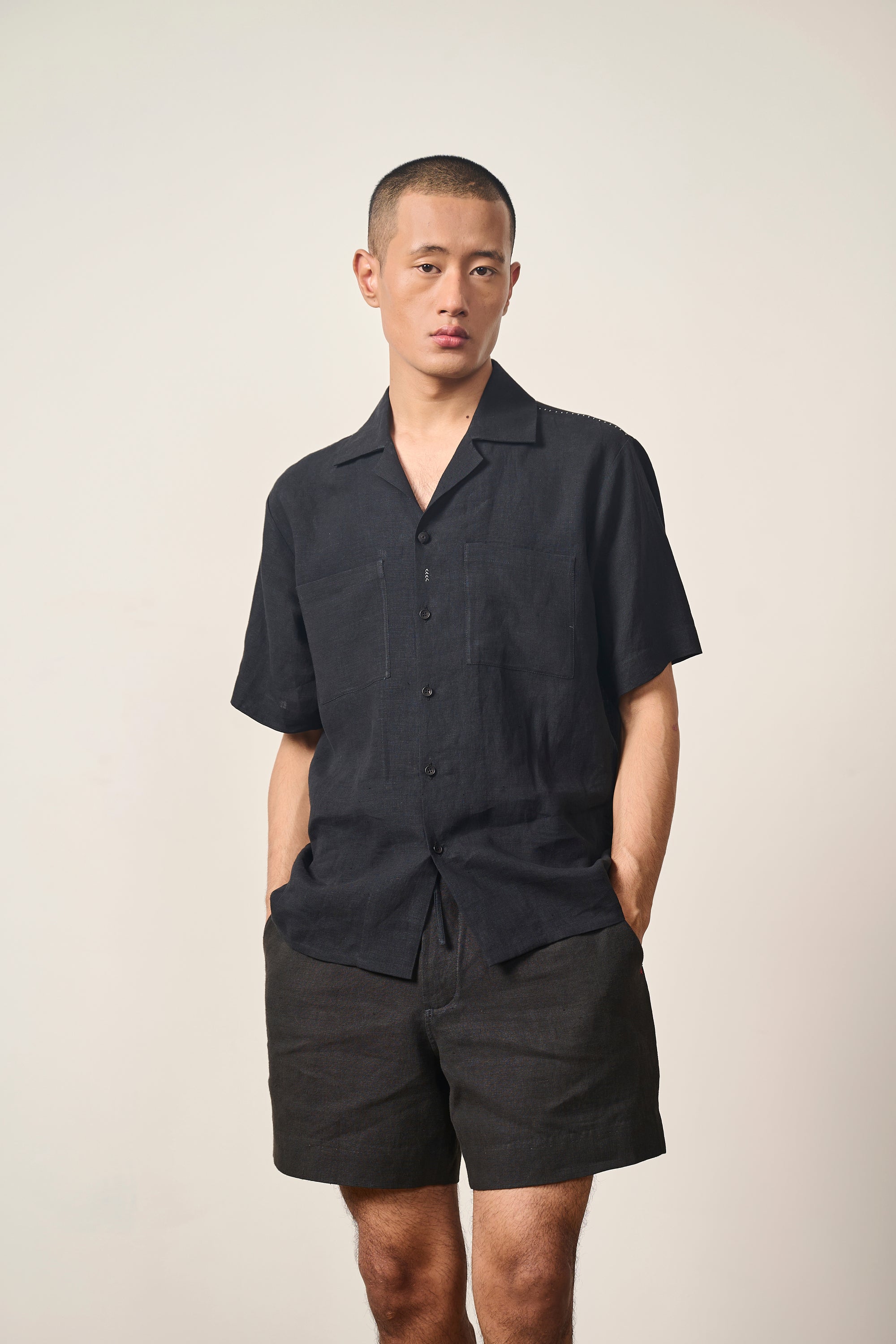 A man wearing black linen shirt