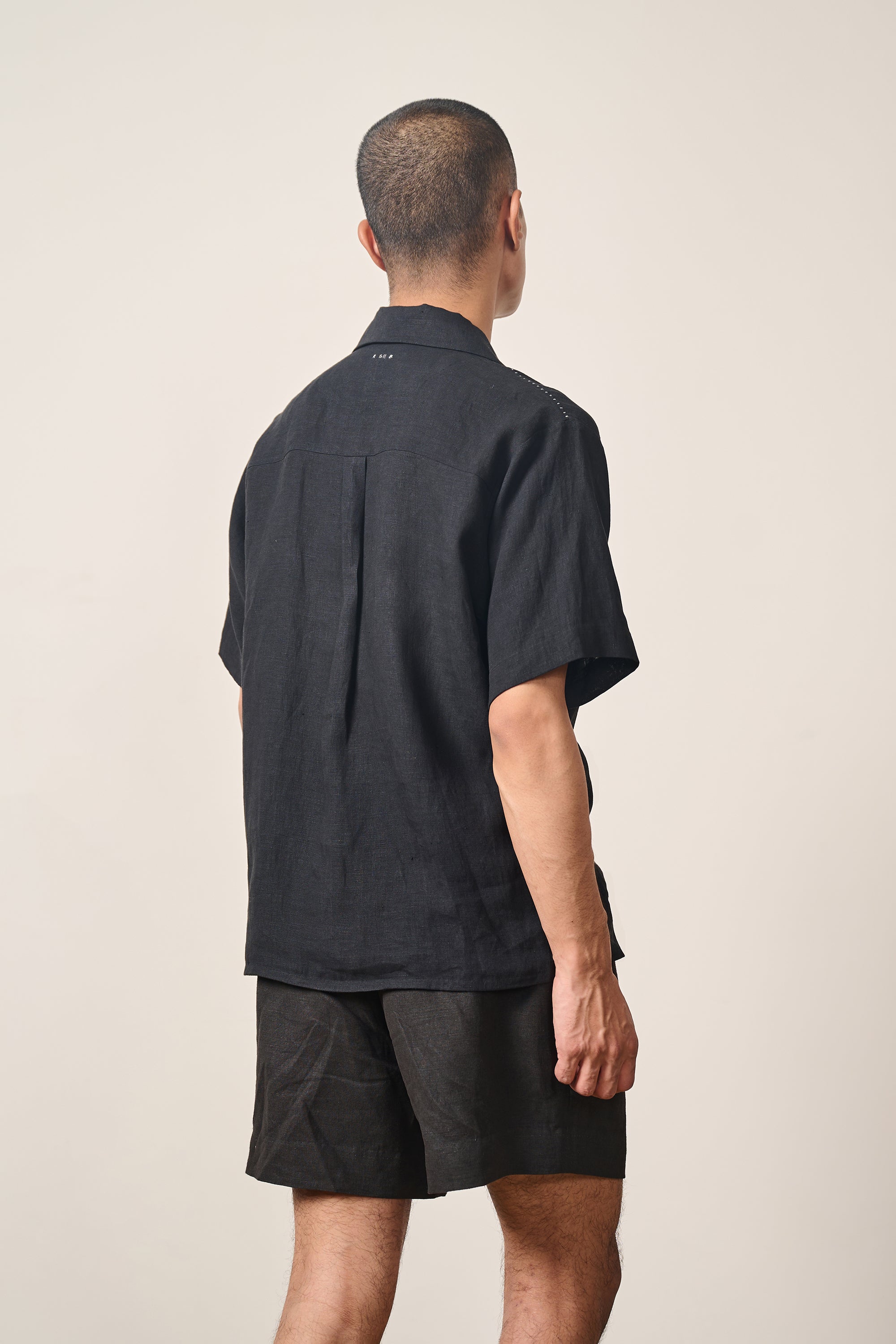 A back shot of a man wearing black shirt