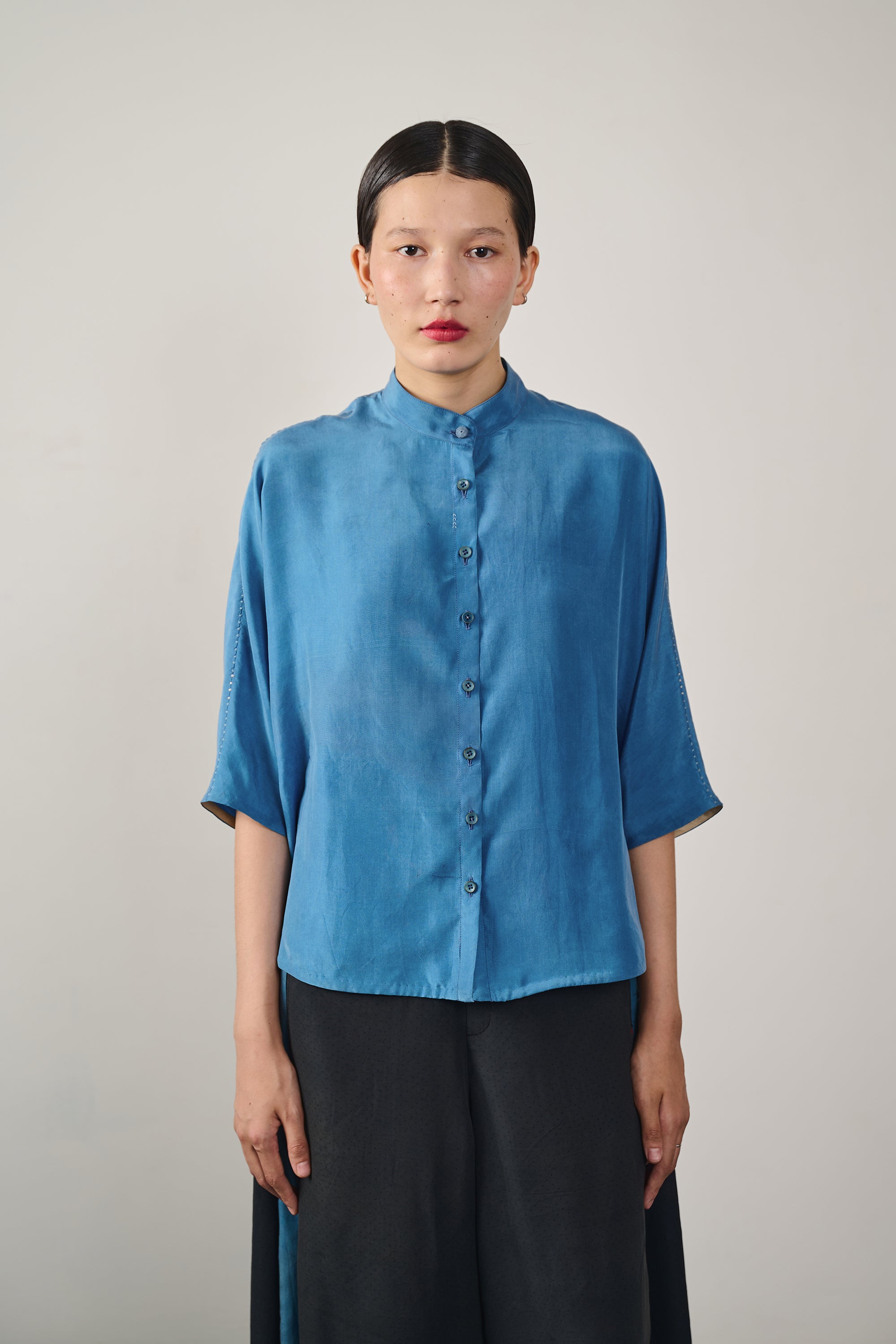 A women wearing medium indigo half sleeves shirt