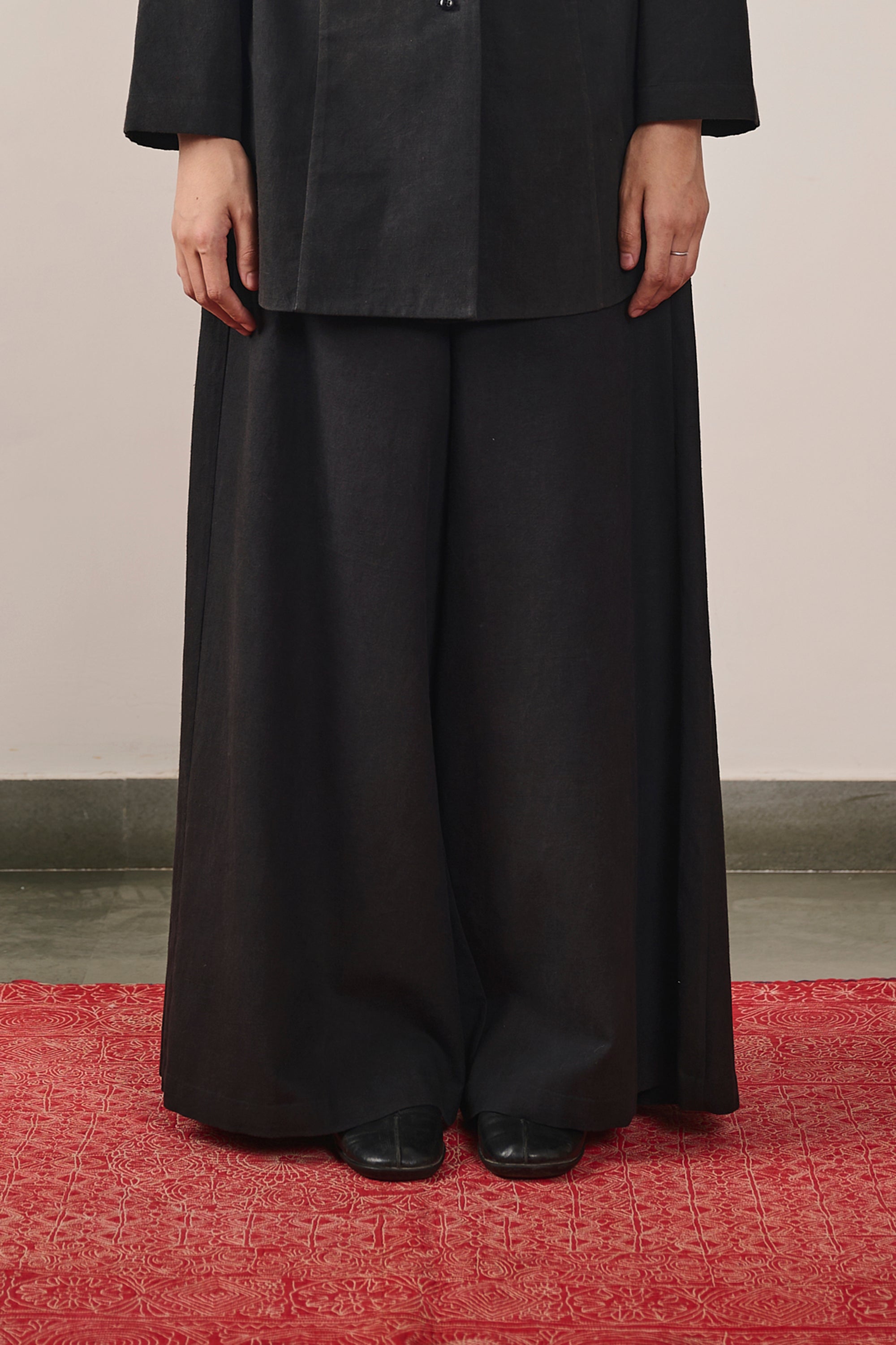 A woman wearing black pant