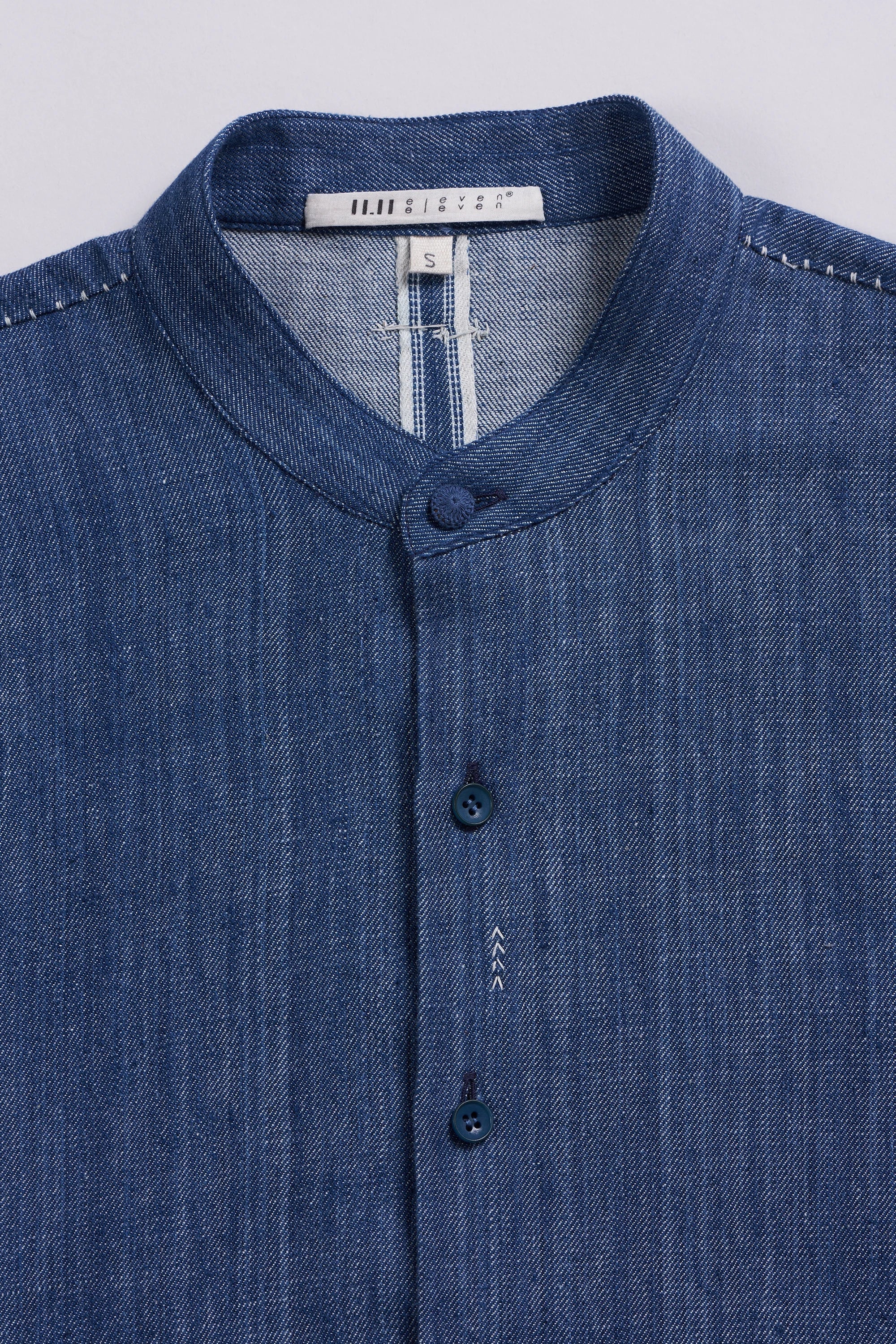 Fabric close-up with buttons and hand detailing