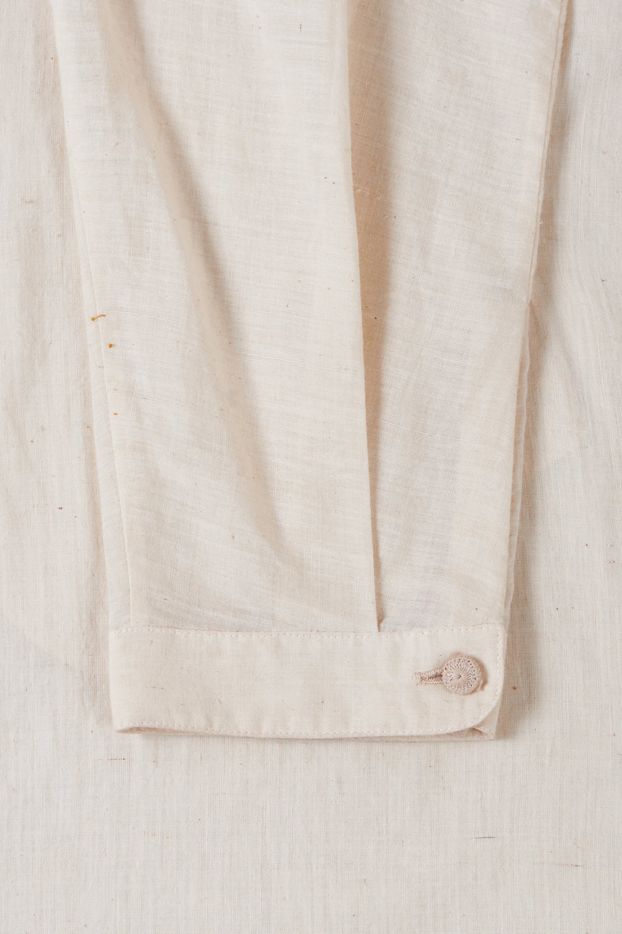 A close-up shot of a ecru cotton shirt