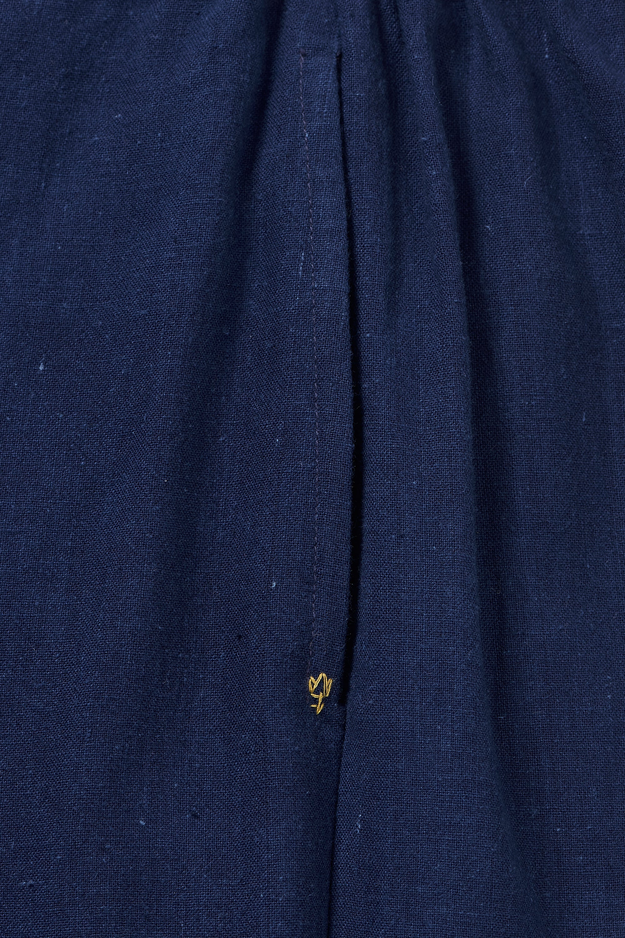 A close-up shot of a indigo pant with pocket