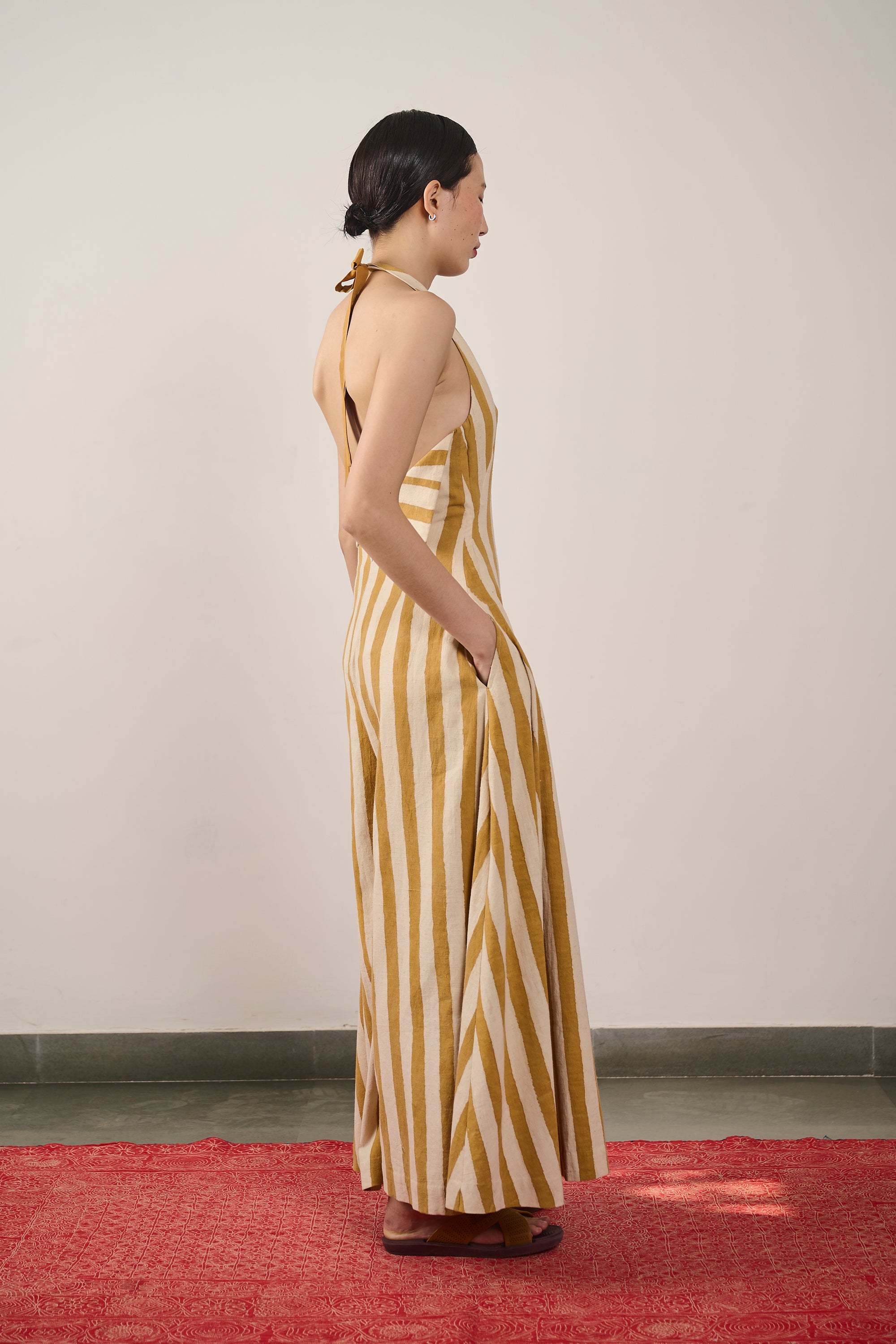 A side shot of a man wearing mustard yellow dress