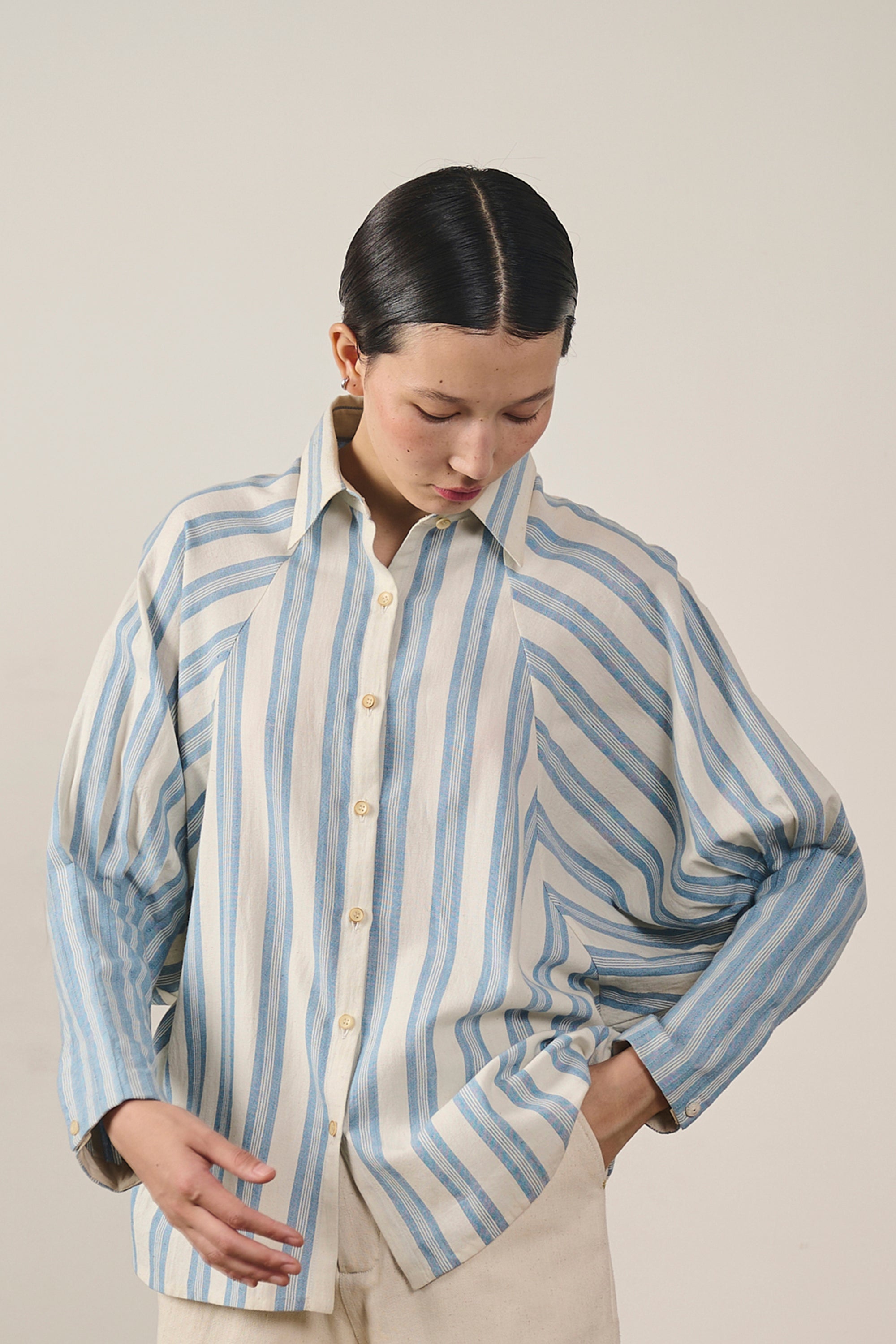 A woman wearing light indigo cotton shirt