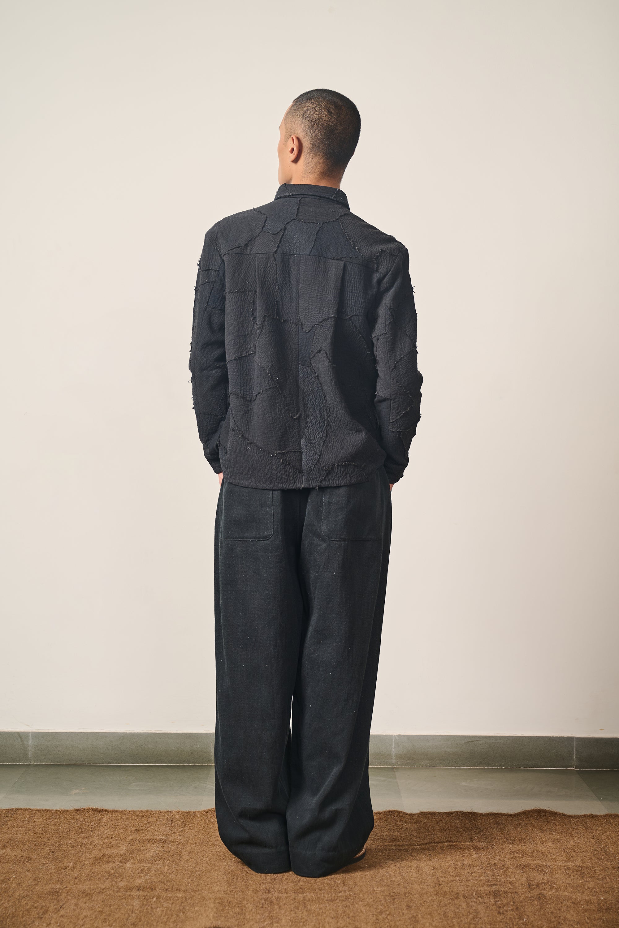A back shot of a man wearing black shirt