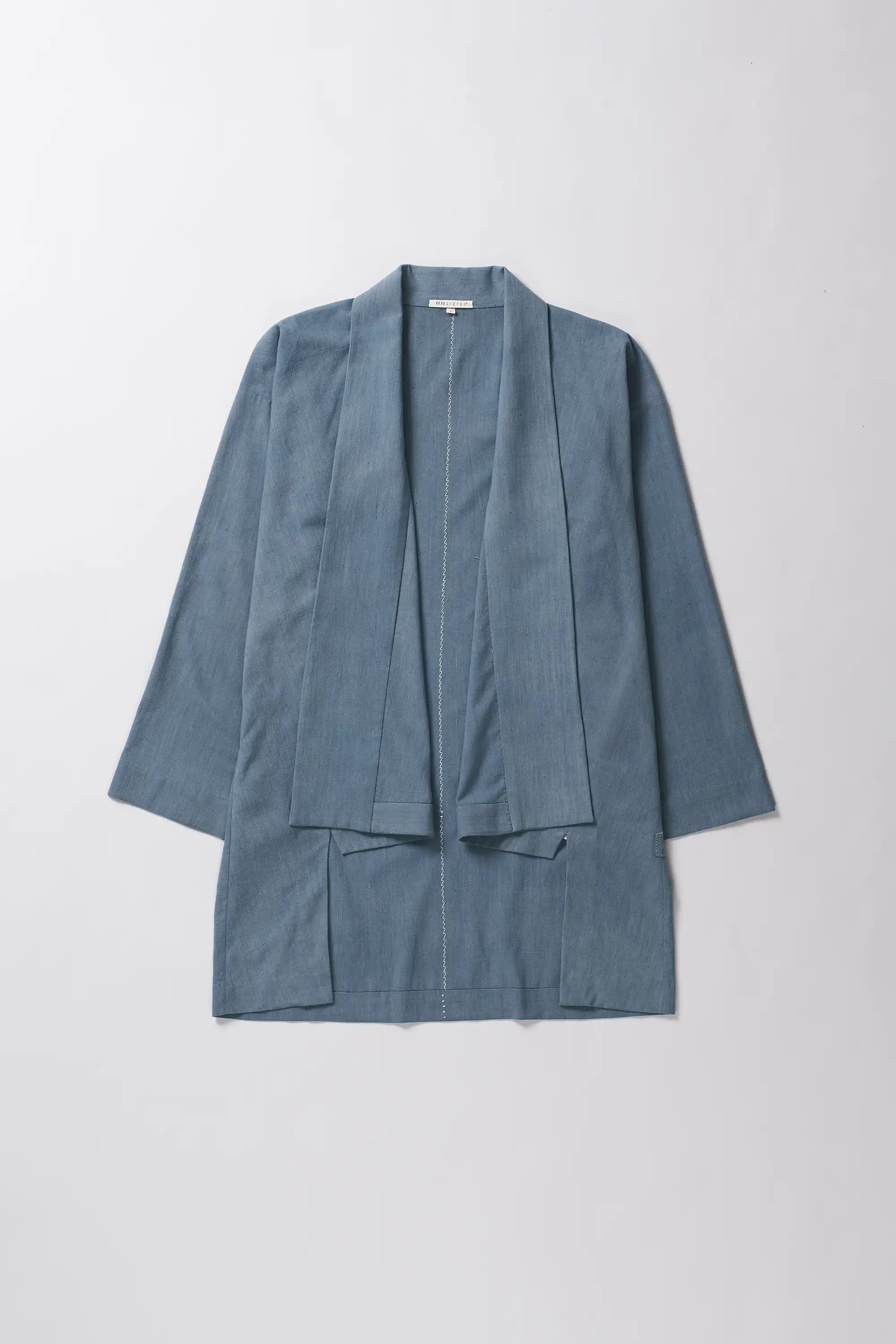 Front image of a powder blue shrug