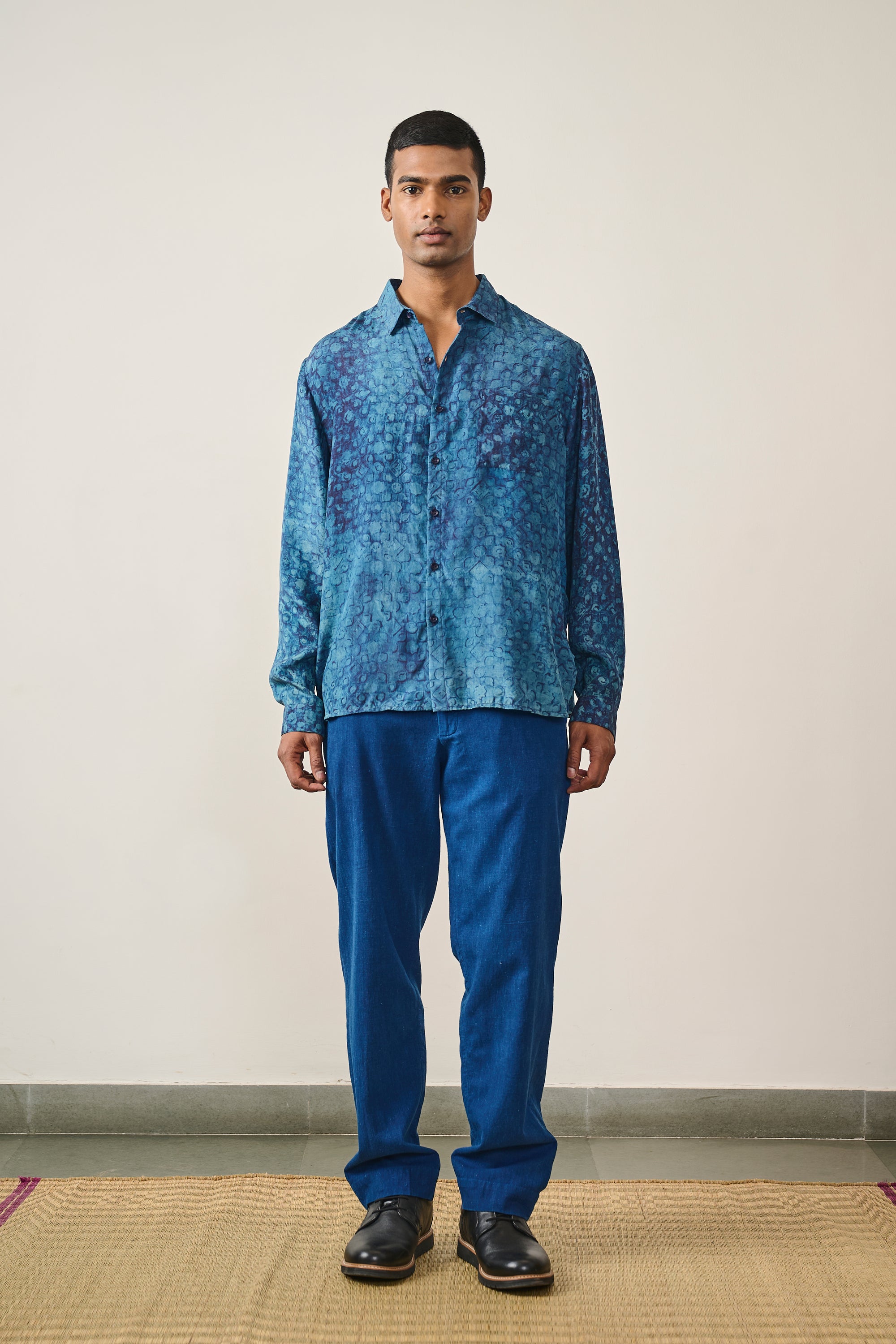 A man wearing medium indigo shirt