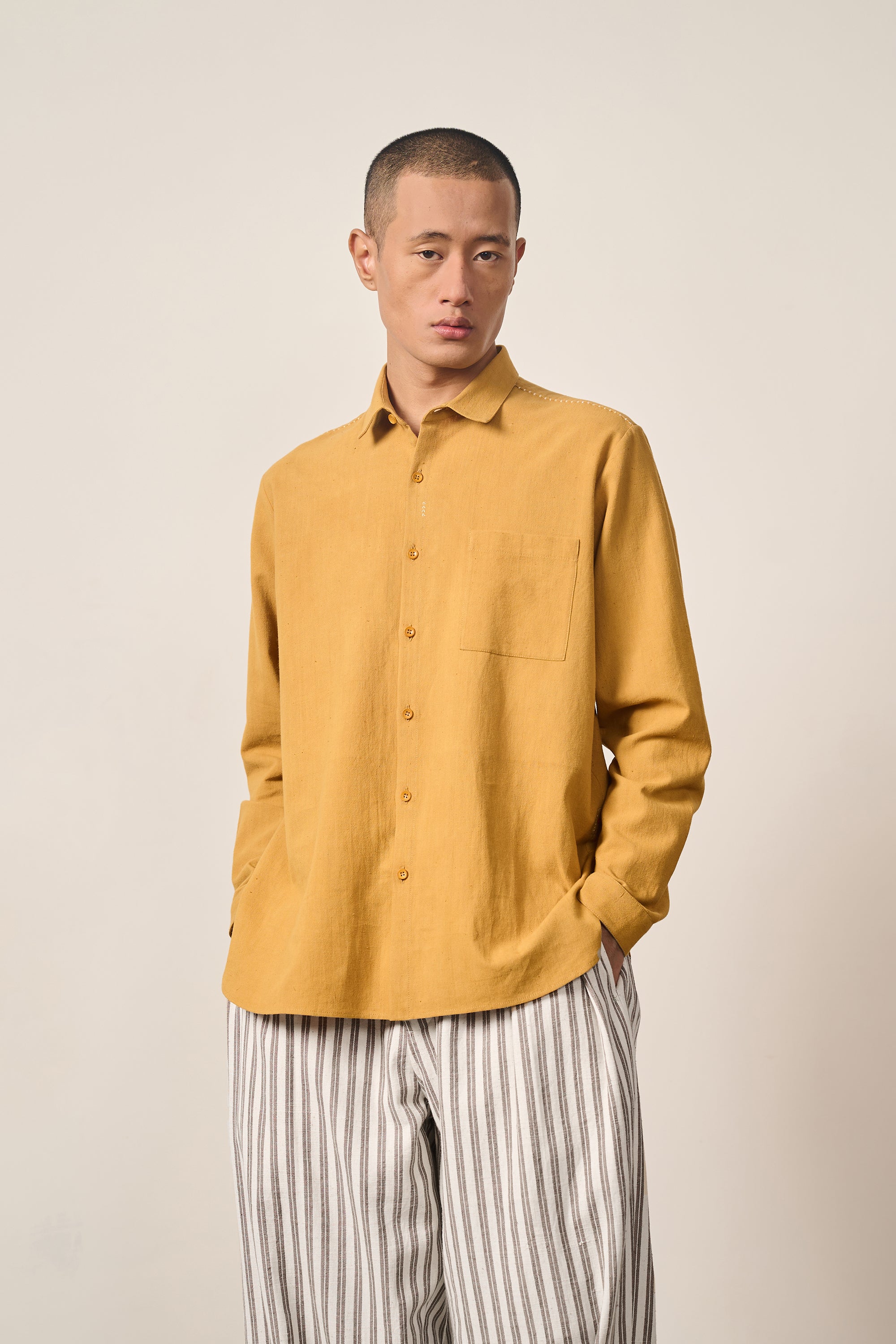 A man wearing mustard yellow shirt