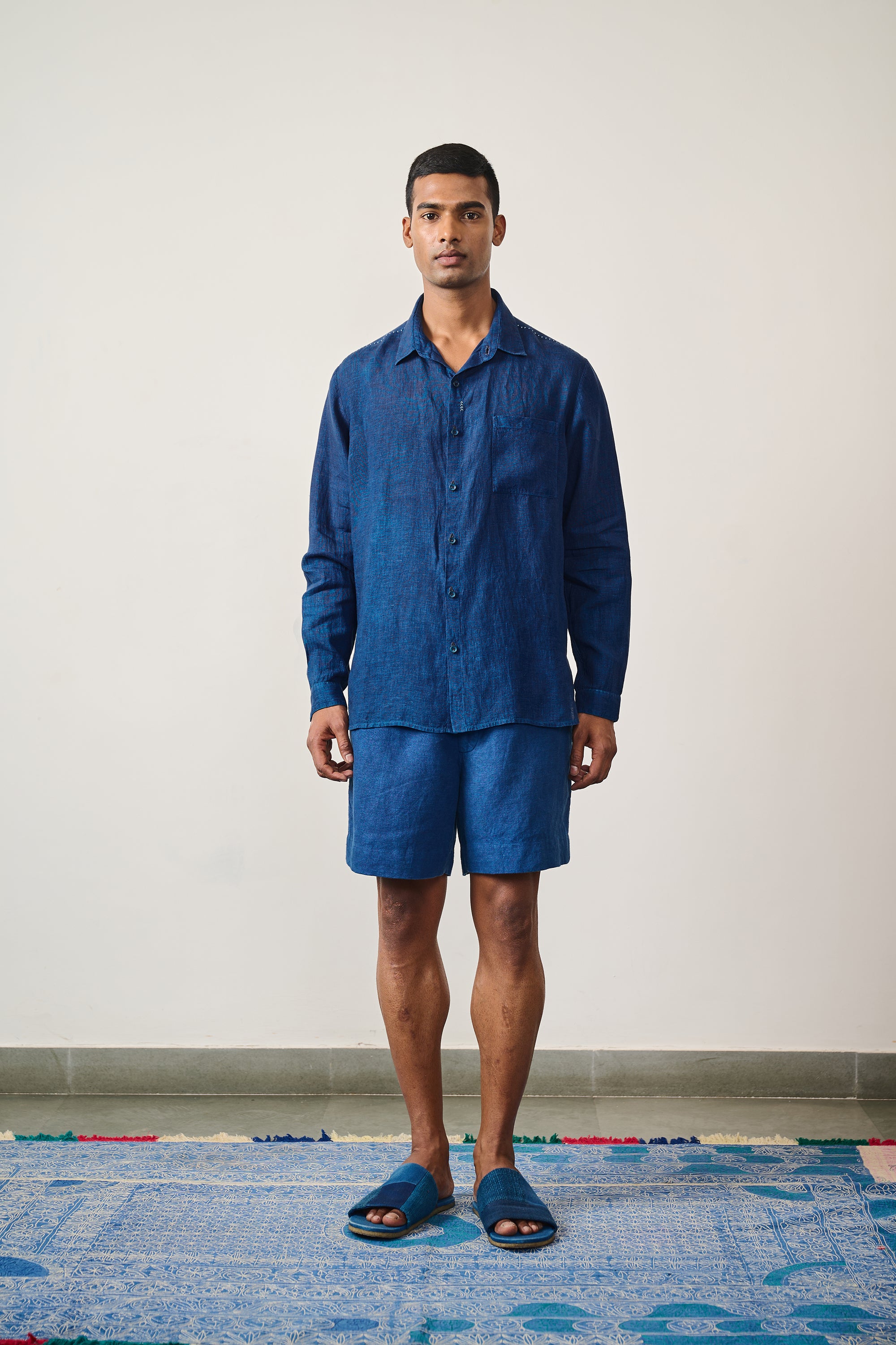 A man wearing medium medium indigo shirt