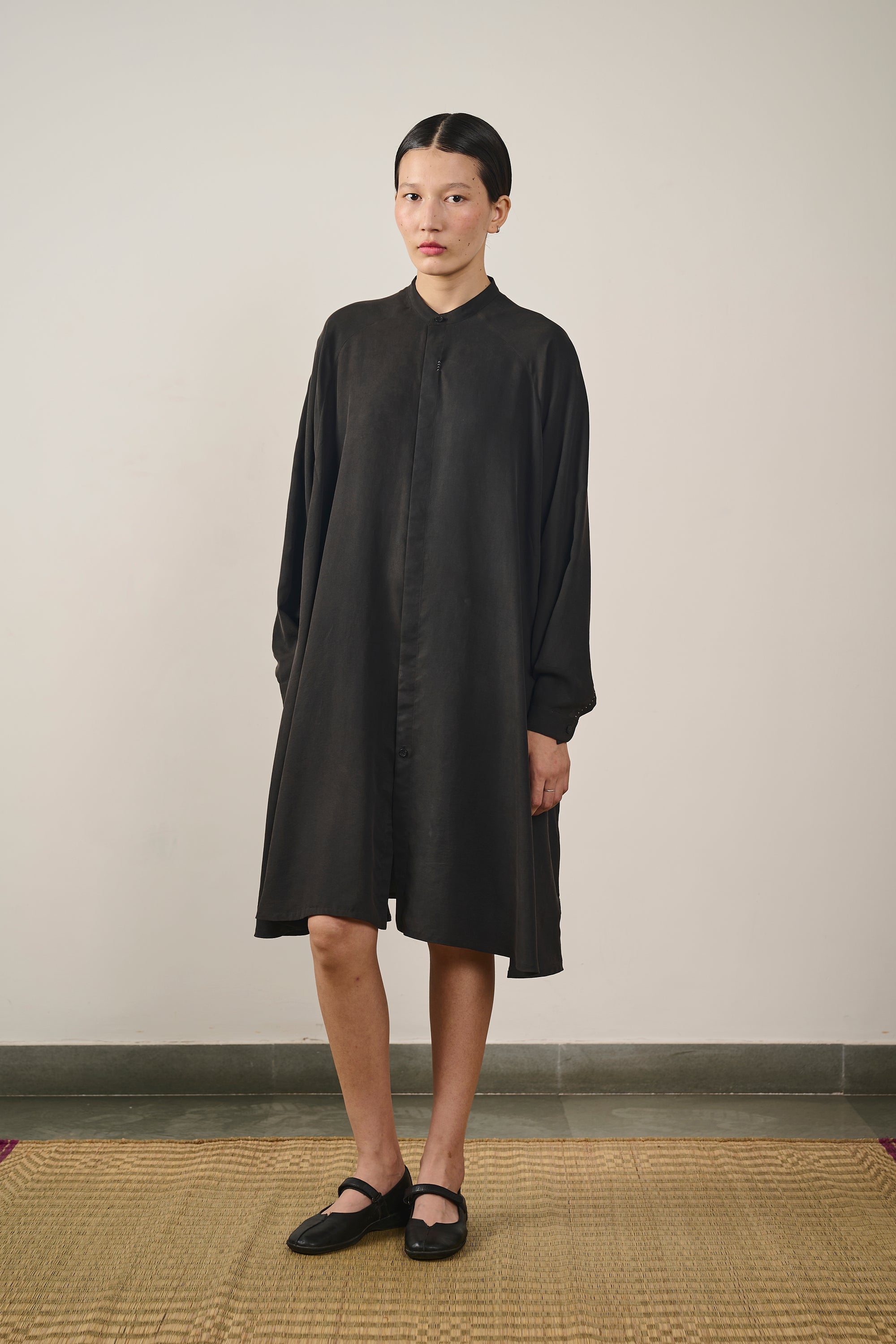A woman wearing black dress with hand detailing