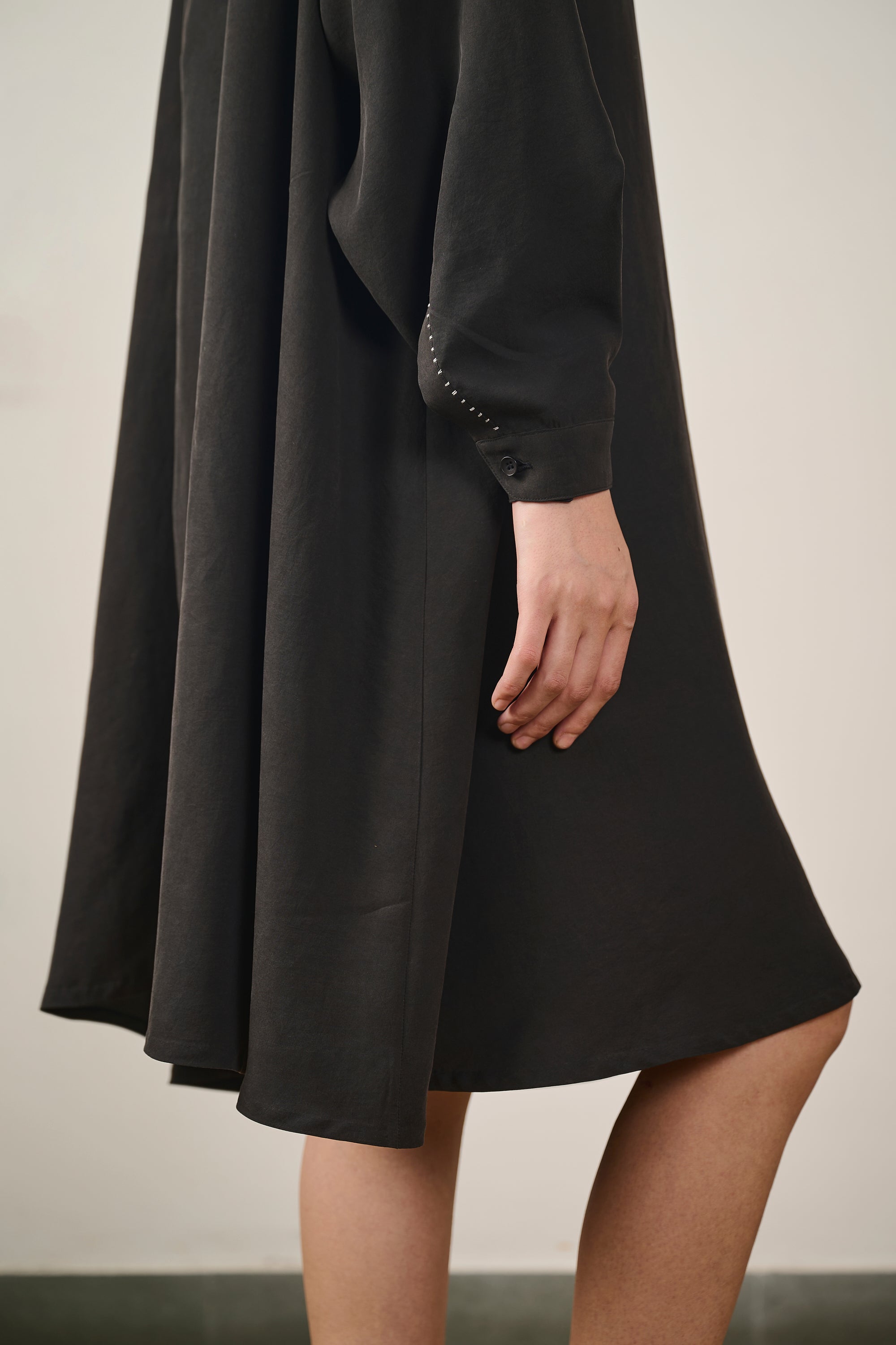 A woman wearing black silk dress