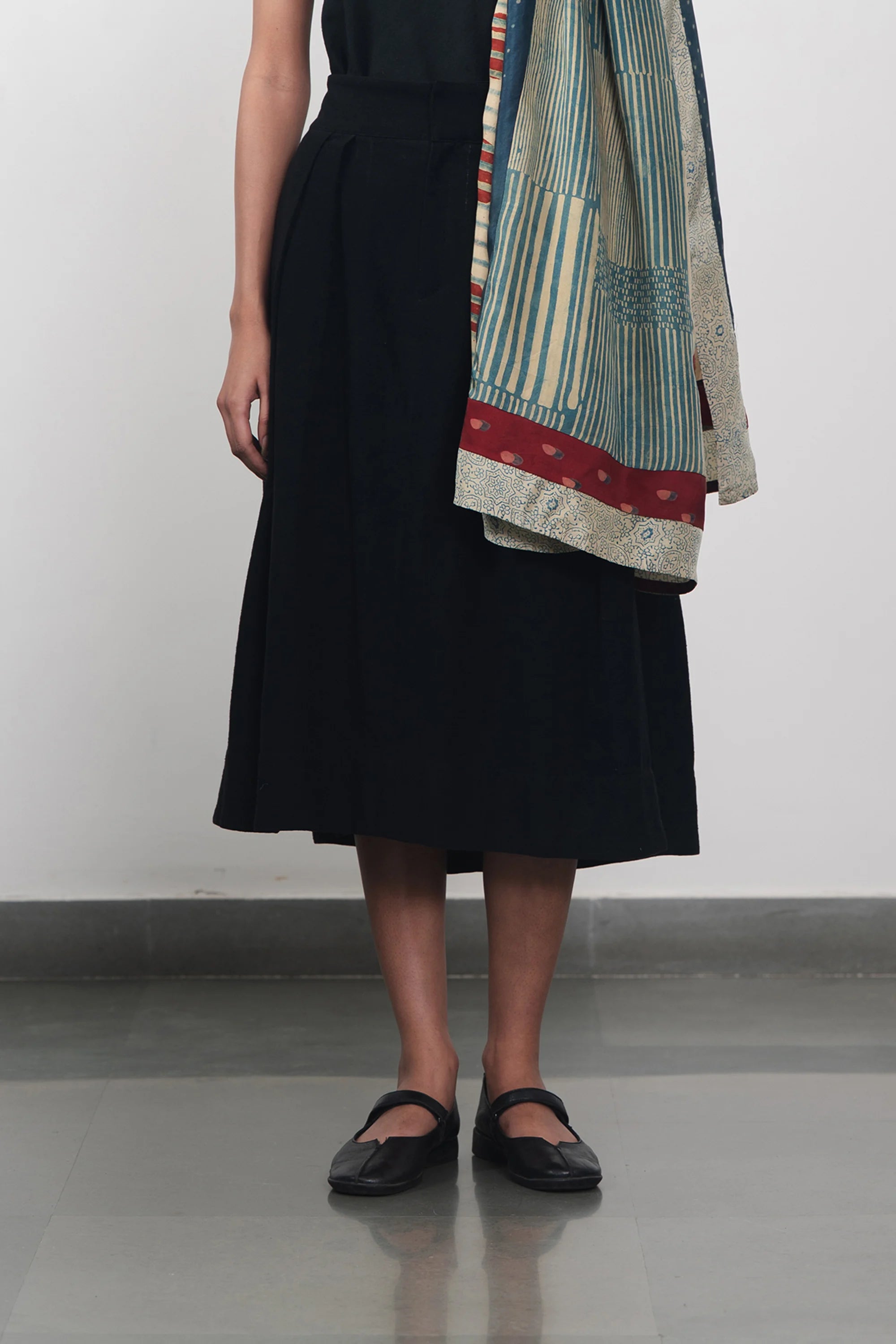 A woman wearing black skirt