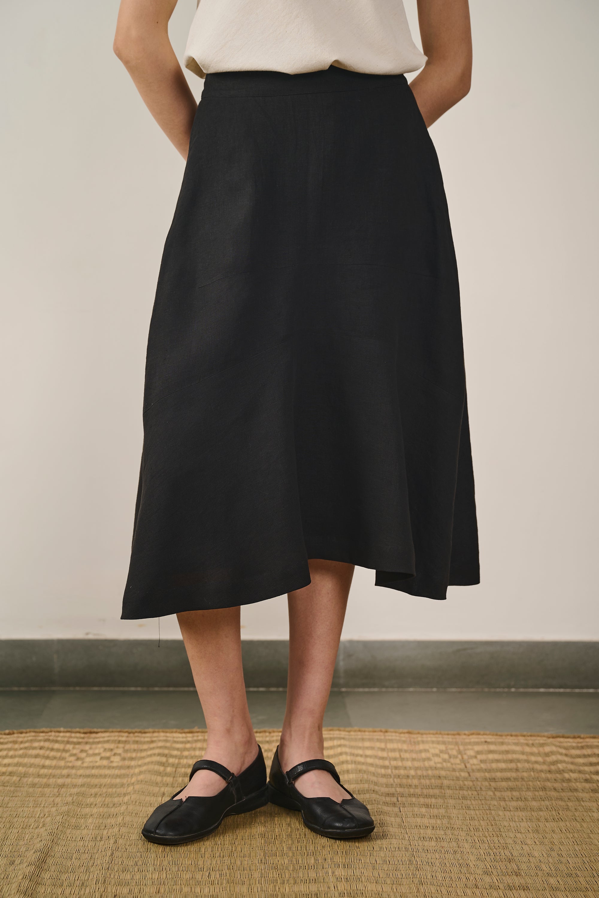 A woman wearing black linen skirt