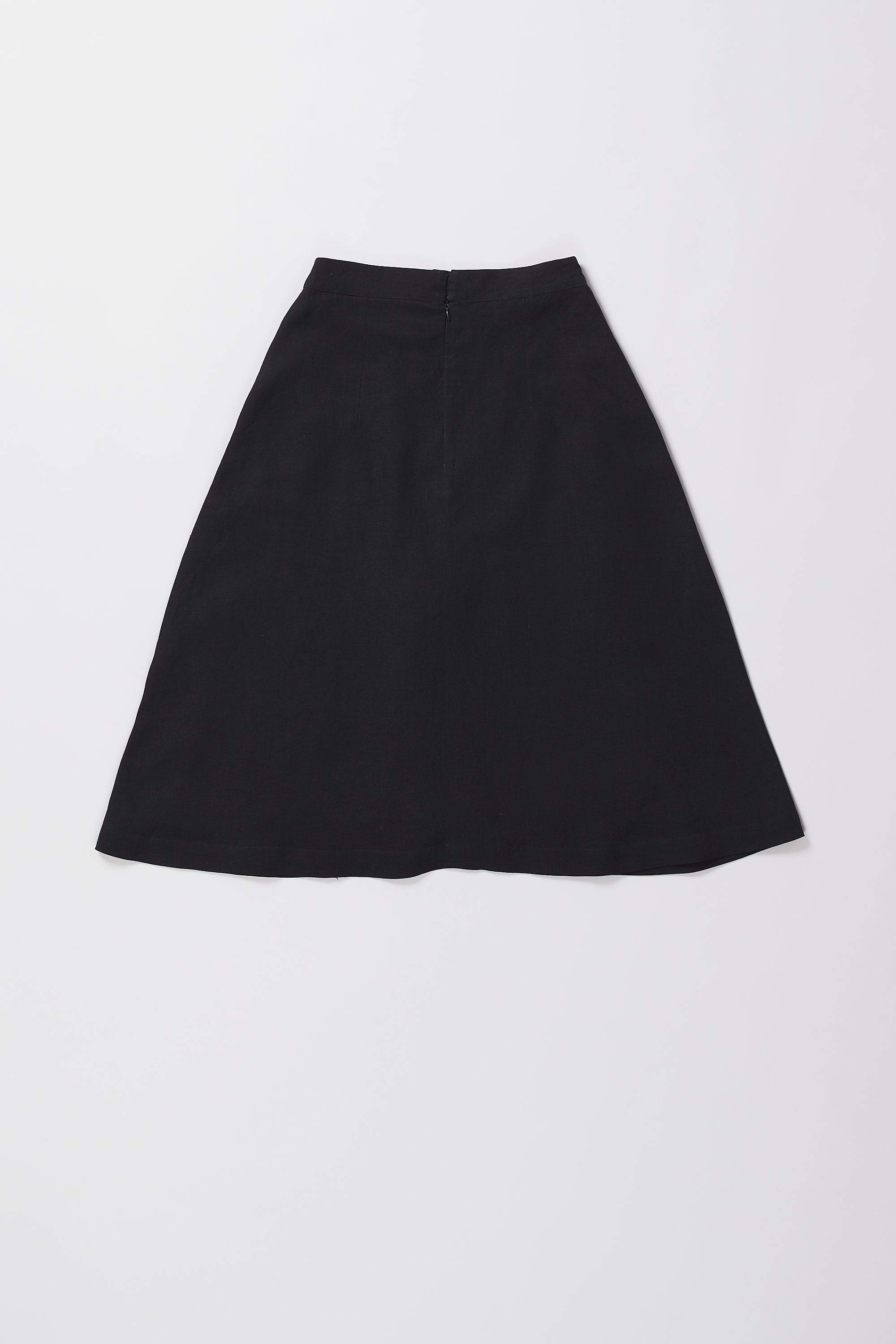 A back shot of a woman wearing black skirt