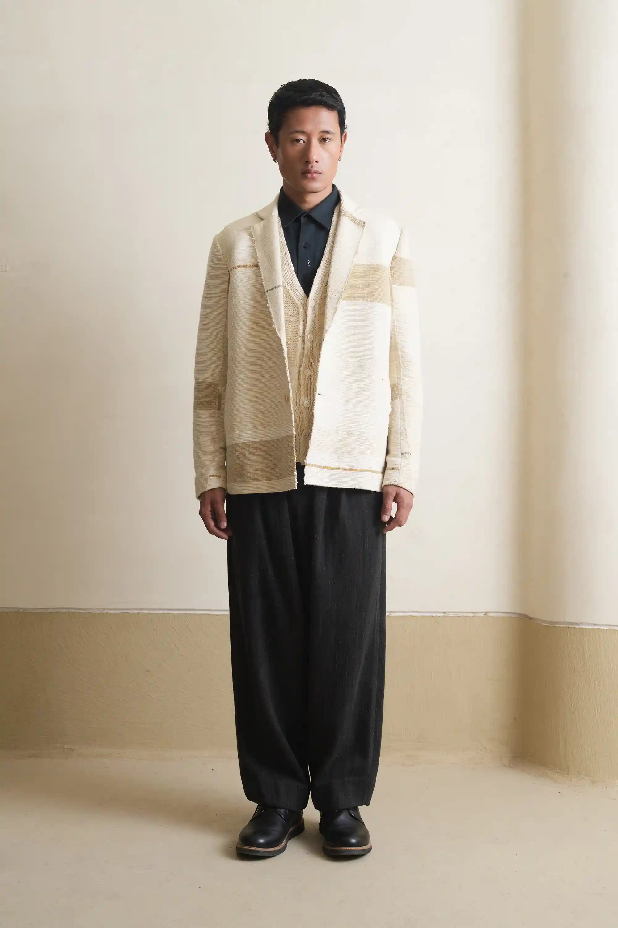 A man wearing ecru patchwork jacket