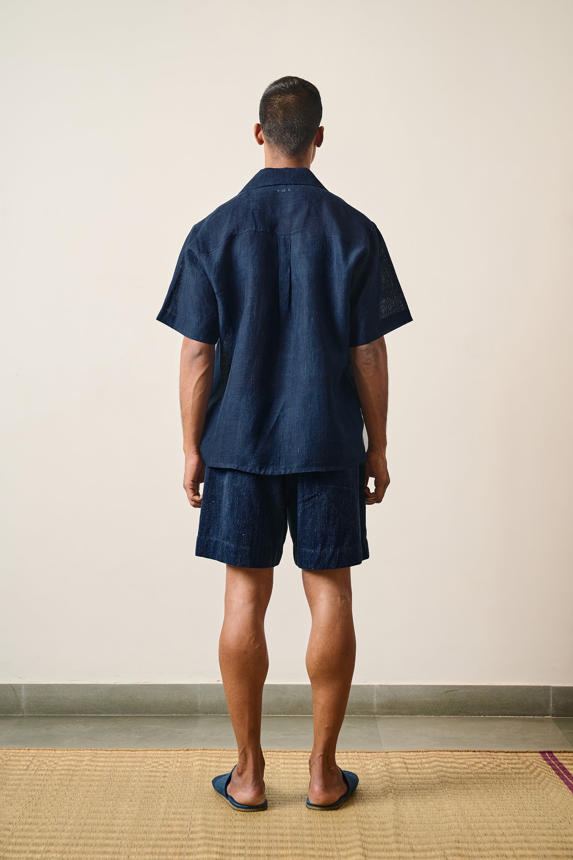 A back shot of a man wearing indigo cotton pant